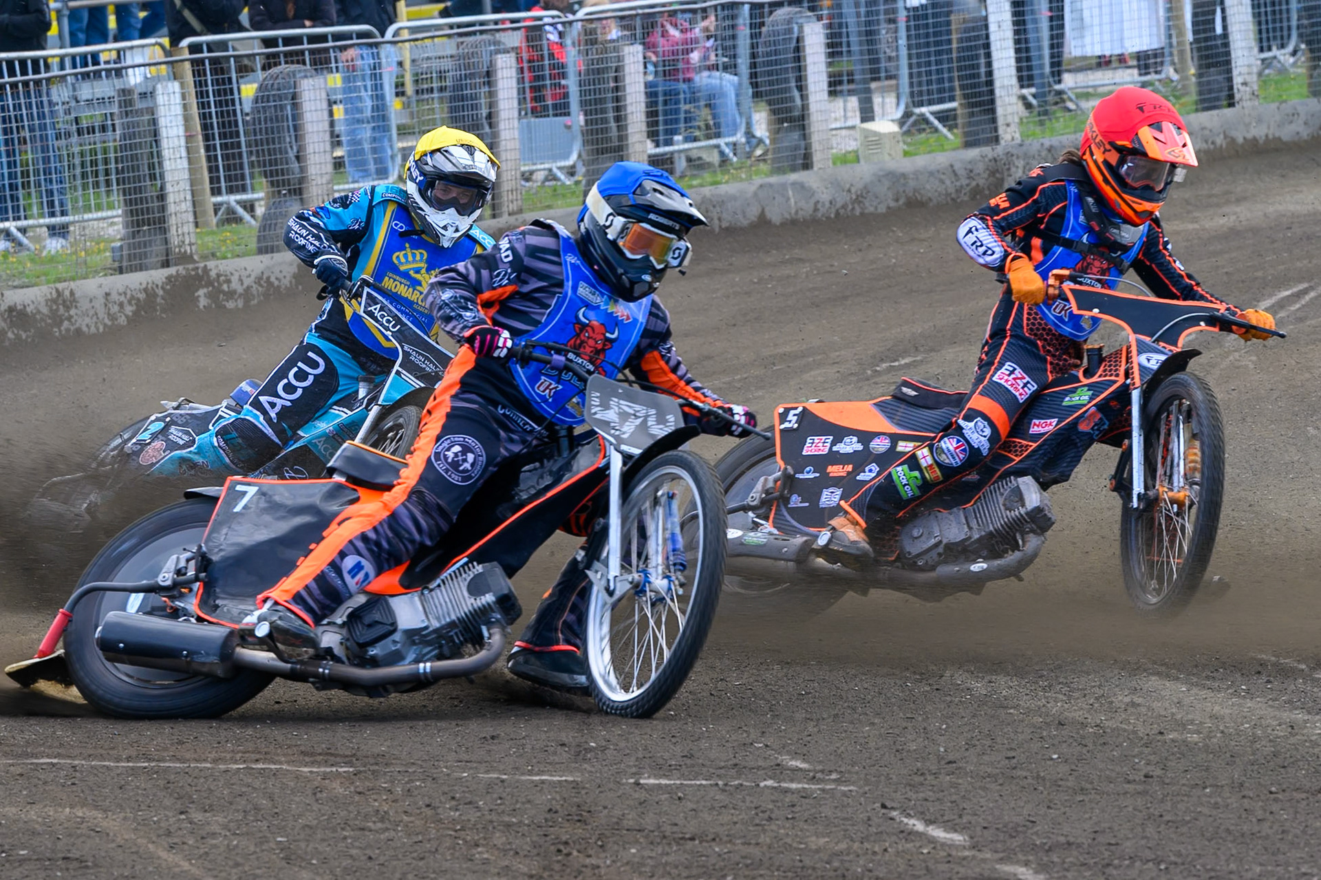 Jack Roberts of Buxton Bulls in Blue rides outside Jack Smith of Buxton Bulls in Red with Jamie Halder of Edinburgh Monarchs Academy in Yellow behind during the WSRA National Development League match between Buxton Bulls and Edinburgh Monarchs Academy at Hi-Edge Speedway, Buxton on Sunday 14th June 2026. (Photo: Ian Charles | MI News)