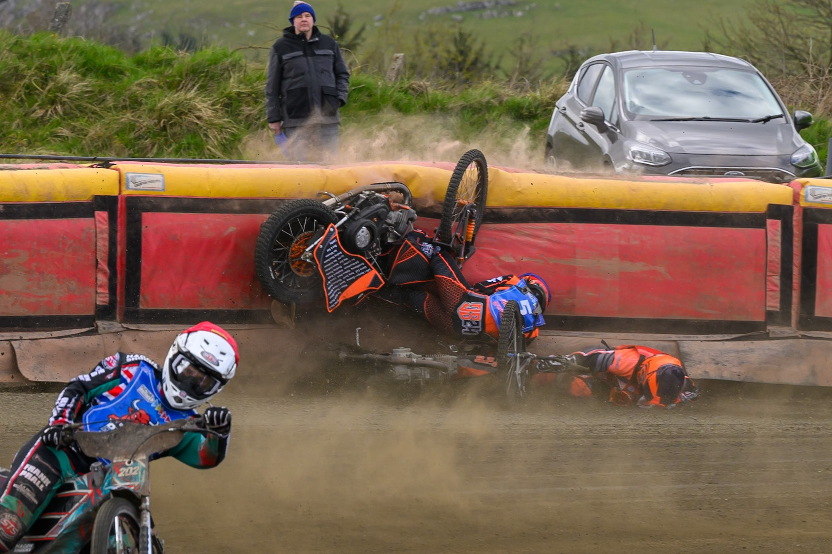 Connor Coles of NDL Nomads   in White fall and Jack Smith of Buxton Bulls   in Blue collides with him during the  Challenge match between Buxton Bulls and NDL Nomads at Hi-Edge Speedway, Buxton on Sunday 19th April 2026. (Photo: Ian Charles | MI News)