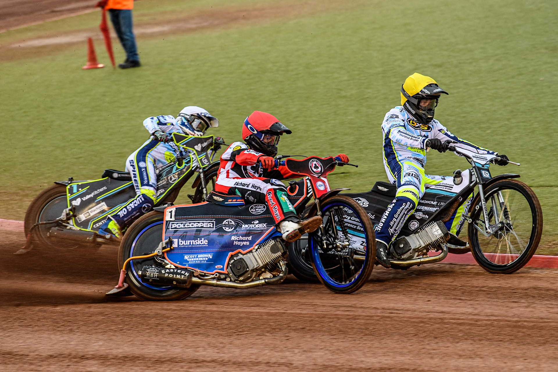 Belle Vue Aces' Brady Kurtz in Red rides outside Oxford Spires' Erik Riss in Yellow and Oxford Spires' Rohan Tungate in White during the Rowe Motor Oil Premiership match between Belle Vue Aces and Oxford Spires at the National Speedway Stadium, Manchester on Monday 13th May 2024. (Photo: Ian Charles | MI News)