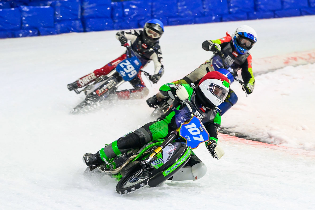 Andrej Divis (107) of Czechia in Red leading Wild Card Harald Simon (16) of Austria  \in White and Martin Posch (299) of Austria  in Blue during the FIM Ice Speedway Gladiators World Championship Final 3 at Ice Rink Thialf, Heerenveen on Saturday 11th April 2026. (Photo: Ian Charles | MI News)