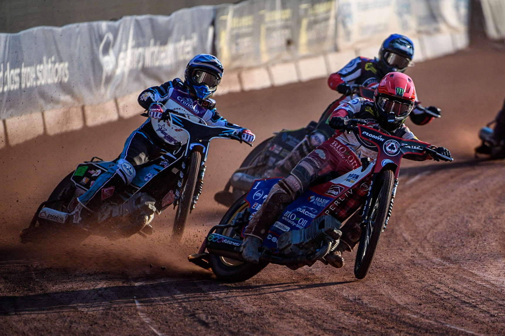 Dan Bewley (Red) leads Vadim Tarasenko (White) and Tom Brennan (Blue) during the Sports Insure Premiership match between Belle Vue Aces and Peterborough at the National Speedway Stadium, Manchester on Monday 19th June 2023. (Photo: Ian Charles | MI News)