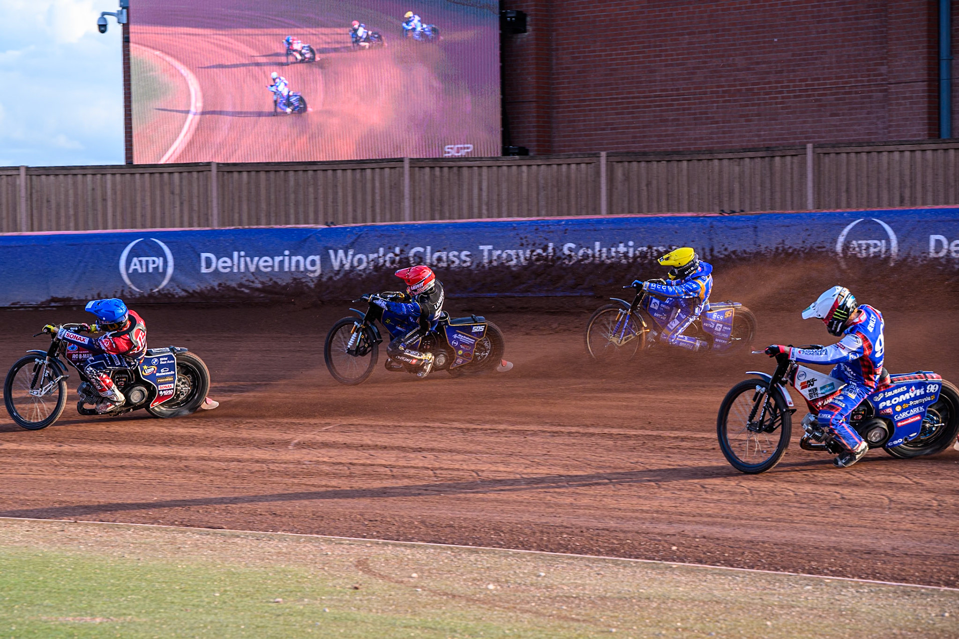 Dominik Kubera (415) of Poland in Blue leading Robert Lambert screen (505) of Great Britain in Red Bartosz Zmarzlik (95) of Poland in Yellow and Dan Bewley (99) of Great Britain in White as they go past the big during the ATPI FIM Speedway Grand Prix Round 5 at the National Speedway Stadium, Manchester, on Saturday 14th June 2025. (Photo: Ian Charles | MI News)