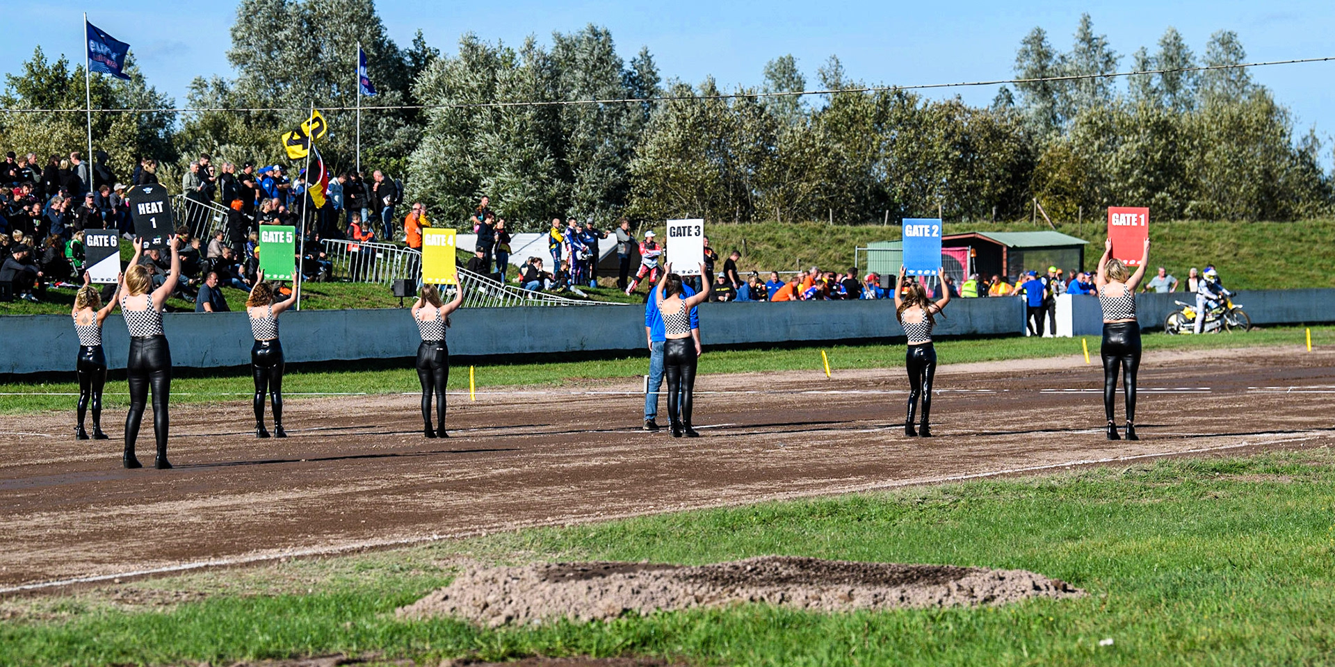 After a three hour wait, the start line girls announce the first heatduring the FIM Long Track Of Nations event at the Speed Centre Roden on Sunday 24th September 2023. (Photo: Ian Charles | MI News)
