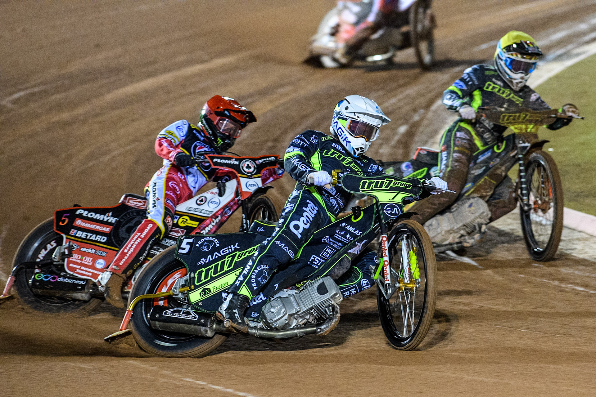 Emil Sayfutdinov of Ipswich Witches in White leading Dan Bewley of Belle Vue Aces in Red and Jordan Jenkins of Ipswich Witches in Yellow during the Premiership Cup Quarter Final 1st Leg match between Belle Vue Aces and Ipswich Witches at the National Speedway Stadium, Manchester on Monday 24th March 2025. (Photo: Ian Charles | MI News)