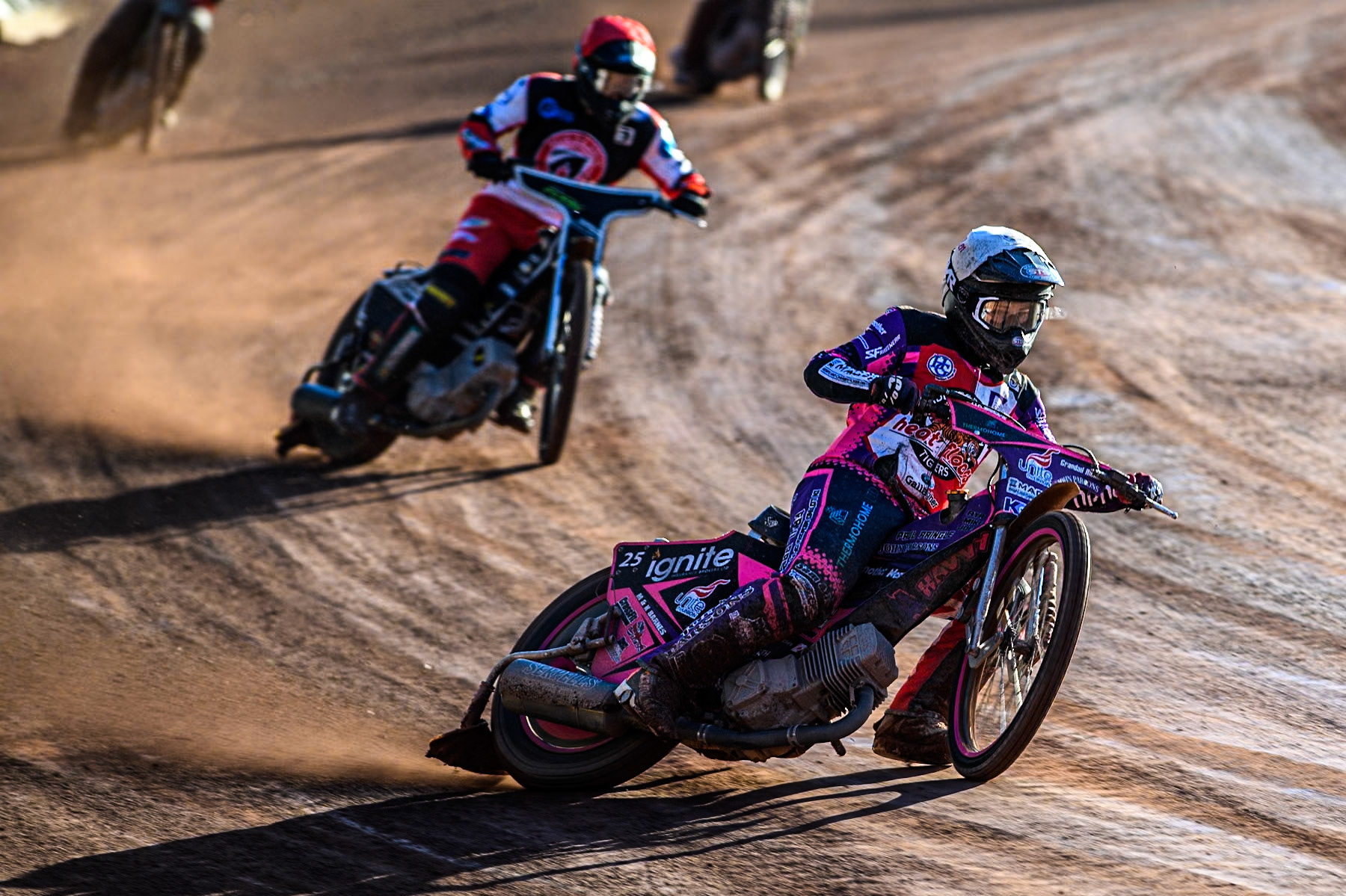 Middlesbrough Tigers' Ben Trigger in White leading Belle Vue Colts' Matt Marson in Red during the WSRA National Development League match between Belle Vue Colts and Middlesbrough Tigers at the National Speedway Stadium, Manchester on Monday 17th June 2024. (Photo: Ian Charles | MI News)