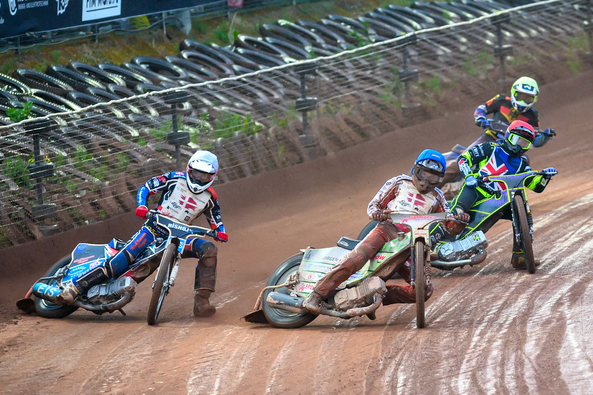 Jonas Knudsen of Denmark in Blue rides inside Frederik Jacobsen of Denmark in White with Reserve Tom Brennan of Great Britain in Red and Mario Hausl of Germany in Yellow during the Speedway GP Qualifying Round 3 at Allied Ashfield Stadium, Glasgow on Saturday 30th May 2026. (Photo: Ian Charles | MI News)
