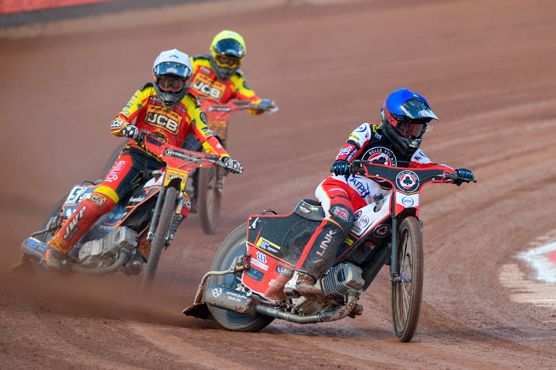 Belle Vue Aces' Zach Cook in Blue leading Leicester Lions' Sam Masters in White and Leicester Lions' Ryan Douglas in Yellow during the Rowe Motor Oil Premiership match between Belle Vue Aces and Leicester Lions at the National Speedway Stadium, Manchester on Monday 19th May 2025. (Photo: Ian Charles | MI News)