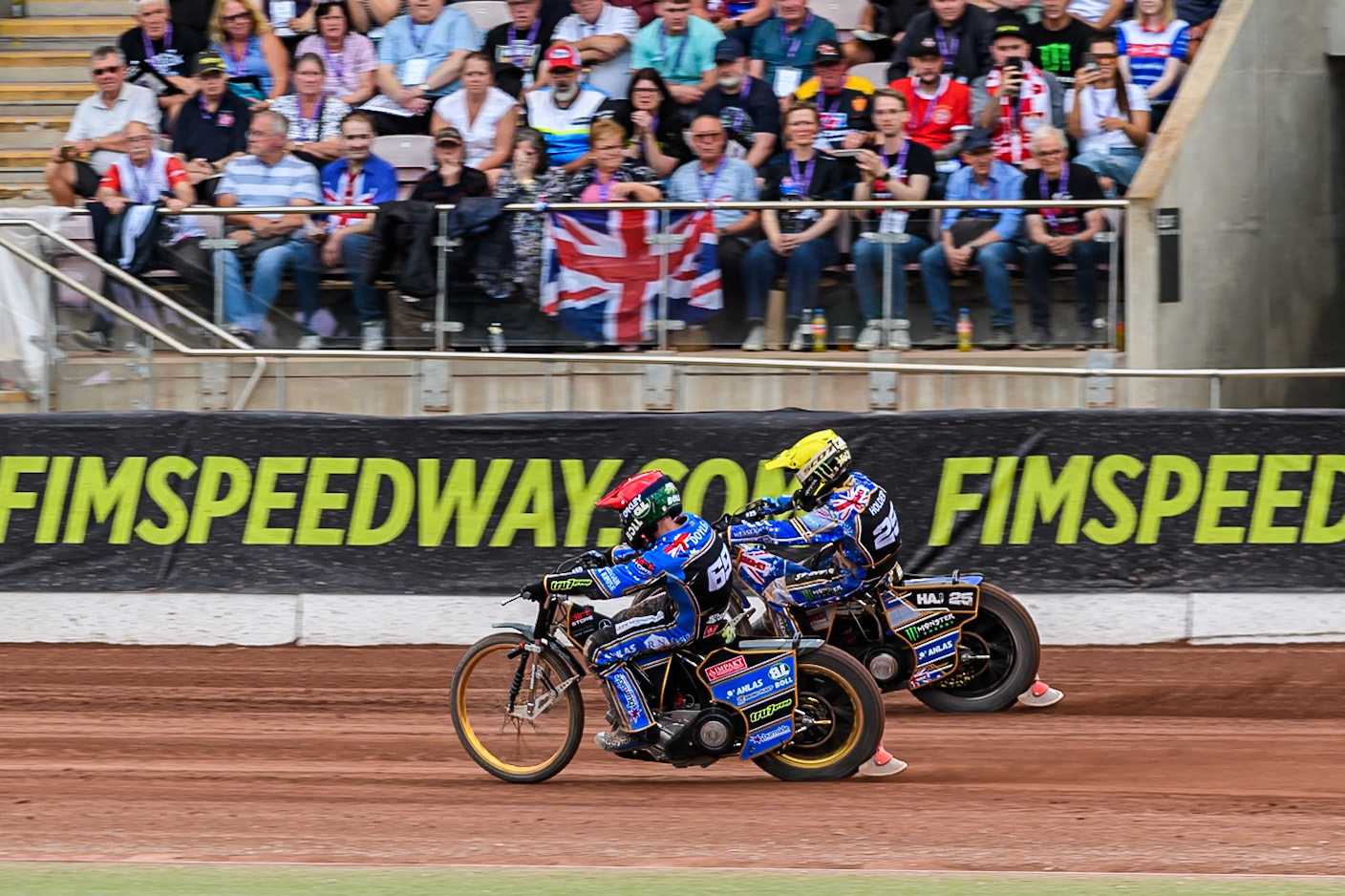 Jason Doyle (69) of Australia in Red on the inside of Jack Holder (25) of Australia in Yellow during the ATPI FIM Speedway Grand Prix Round 4 at the National Speedway Stadium, Manchester, on Friday 13th June 2025. (Photo: Ian Charles | MI News)