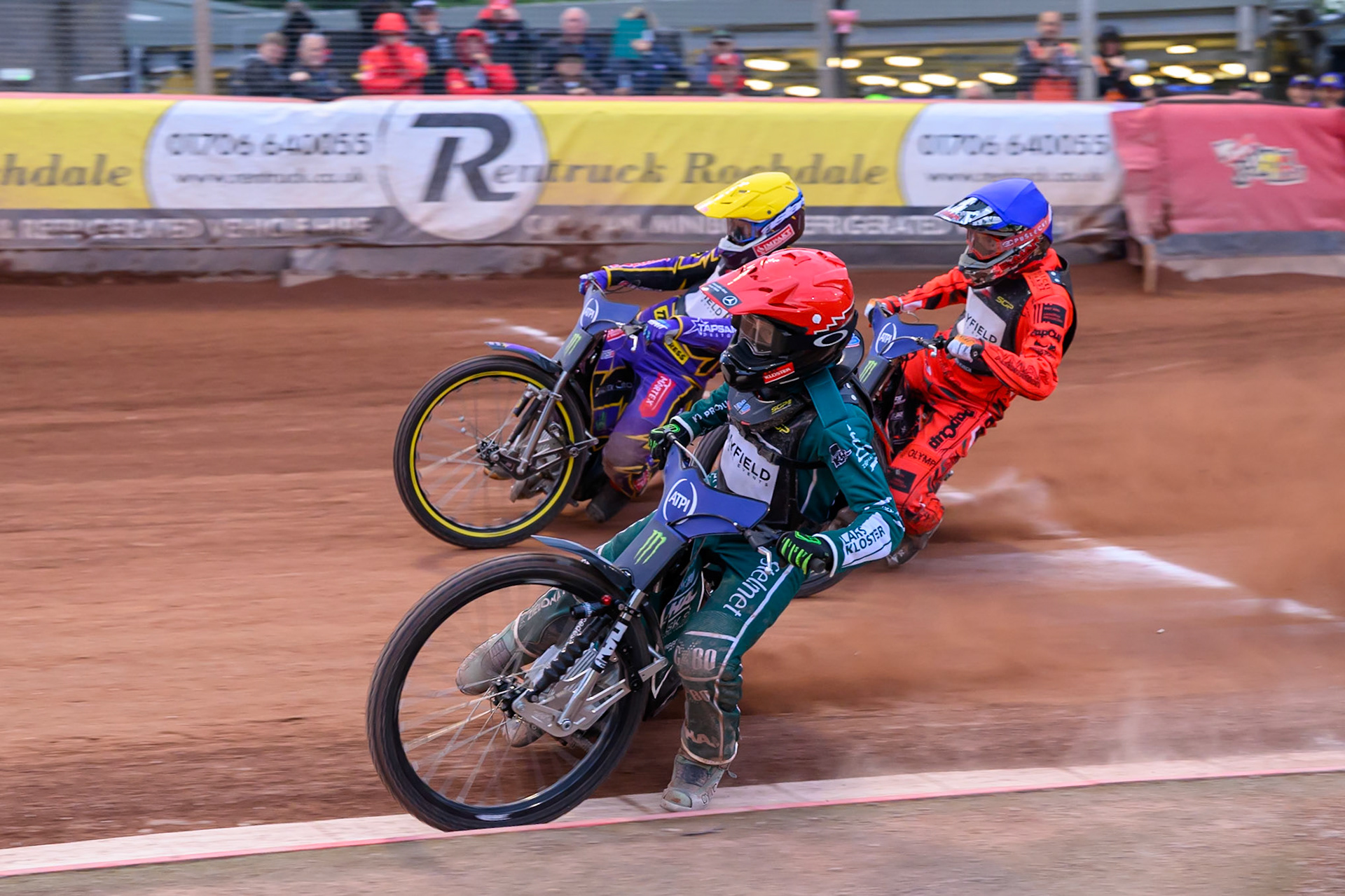 Leon Madsen (30) of Denmark in Red rides inside Jan Kvech (201) of Czech Republic in Blue and Kacper Woryna (223) of Poland in Yellow during the ATPI  FIM Speedway GP of Manchester at the National Speedway Stadium, Manchester on Friday 5th June 2026. (Photo: Ian Charles | MI News)