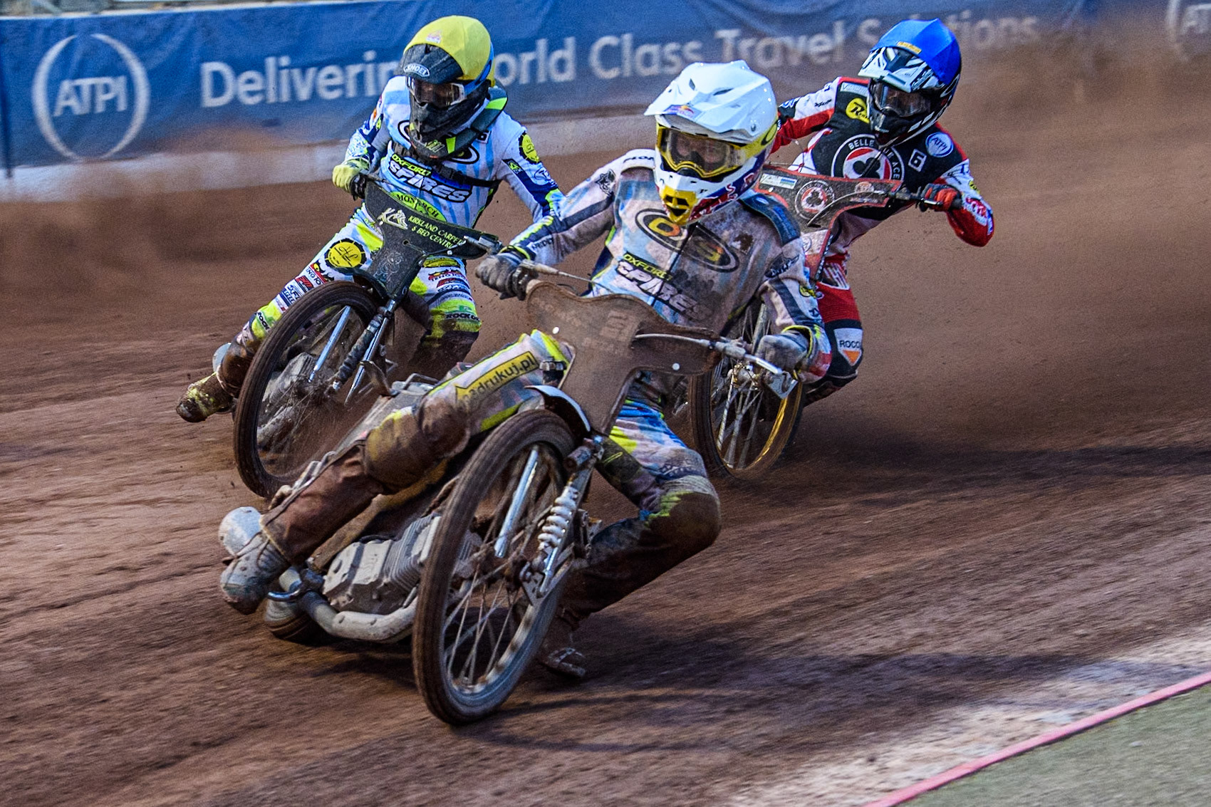 Oxford Spires' Maciej Janowski in White leading Belle Vue Aces' Connor Mountain in Blue and Oxford Spires' Craig Cook in Yellow during the Rowe Motor Oil Premiership match between Belle Vue Aces and Oxford Spires at the National Speedway Stadium, Manchester on Monday 13th May 2024. (Photo: Ian Charles | MI News)