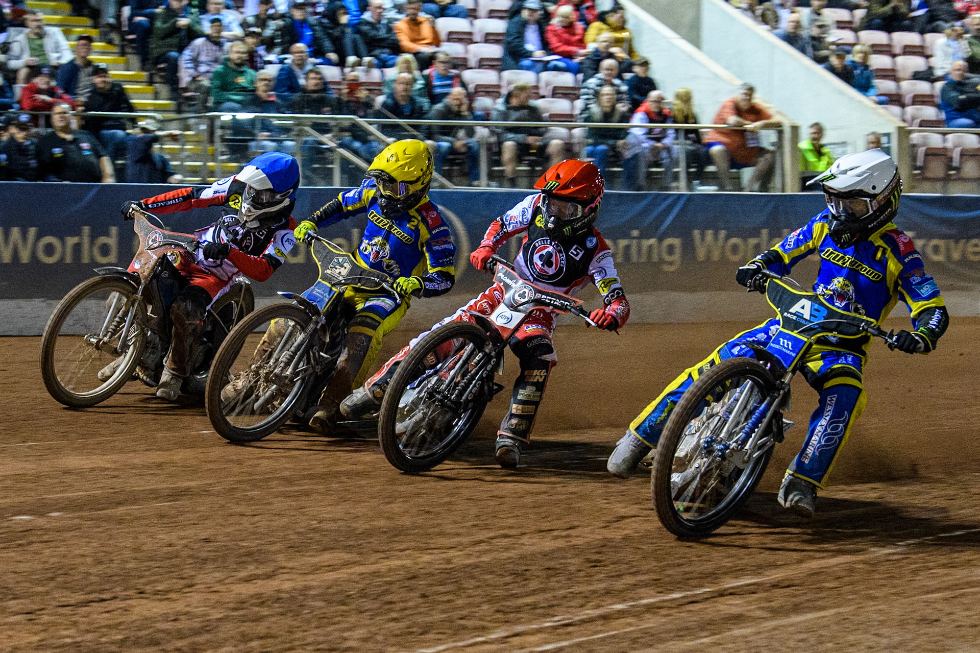 Sheffield Tigers' Jack Holder  in White rides inside Belle Vue Aces' Dan Bewley  in Red, Sheffield Tigers' Kyle Howarth  in Yellow and Belle Vue Aces' Antti Vuolas  in Blue during the Rowe Motor Oil Premiership Play Off Semi Final 2, 1st Leg match between Belle Vue Aces and Sheffield Tigers at the National Speedway Stadium, Manchester on Monday 16th September 2024. (Photo: Ian Charles | MI News)