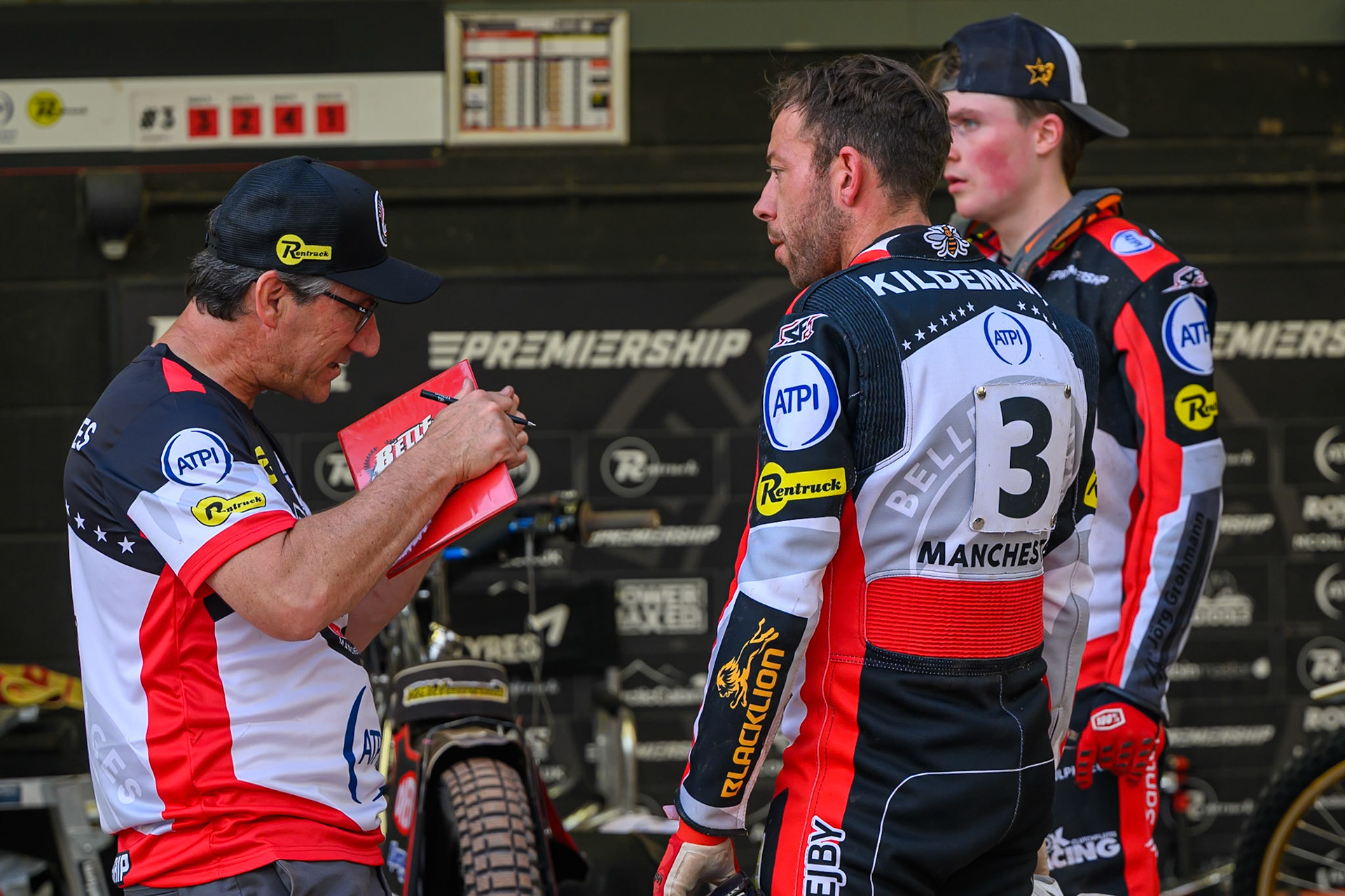 Mark Lemon, Team Manager of Belle Vue Aces (Left) talks with Peter Kildemand of Belle Vue Aces (Centre) and Norick Blödorn of Belle Vue Aces (Right) during the Rowe Motor Oil Premiership match between Belle Vue Aces and Ipswich Witches at the National Speedway Stadium, Manchester on Saturday 20th June 2026. (Photo: Ian Charles | MI News)