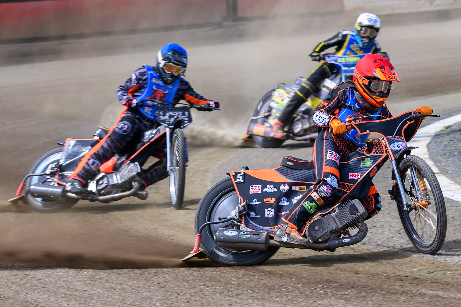 Jack Smith of Buxton Bulls  in Red leading Jack Roberts of Buxton Bulls  in Blue and Dayle Wood of Edinburgh Monarchs Academy   in White during the WSRA National Development League match between Buxton Bulls and Edinburgh Monarchs Academy at Hi-Edge Speedway, Buxton on Sunday 14th June 2026. (Photo: Ian Charles | MI News)
