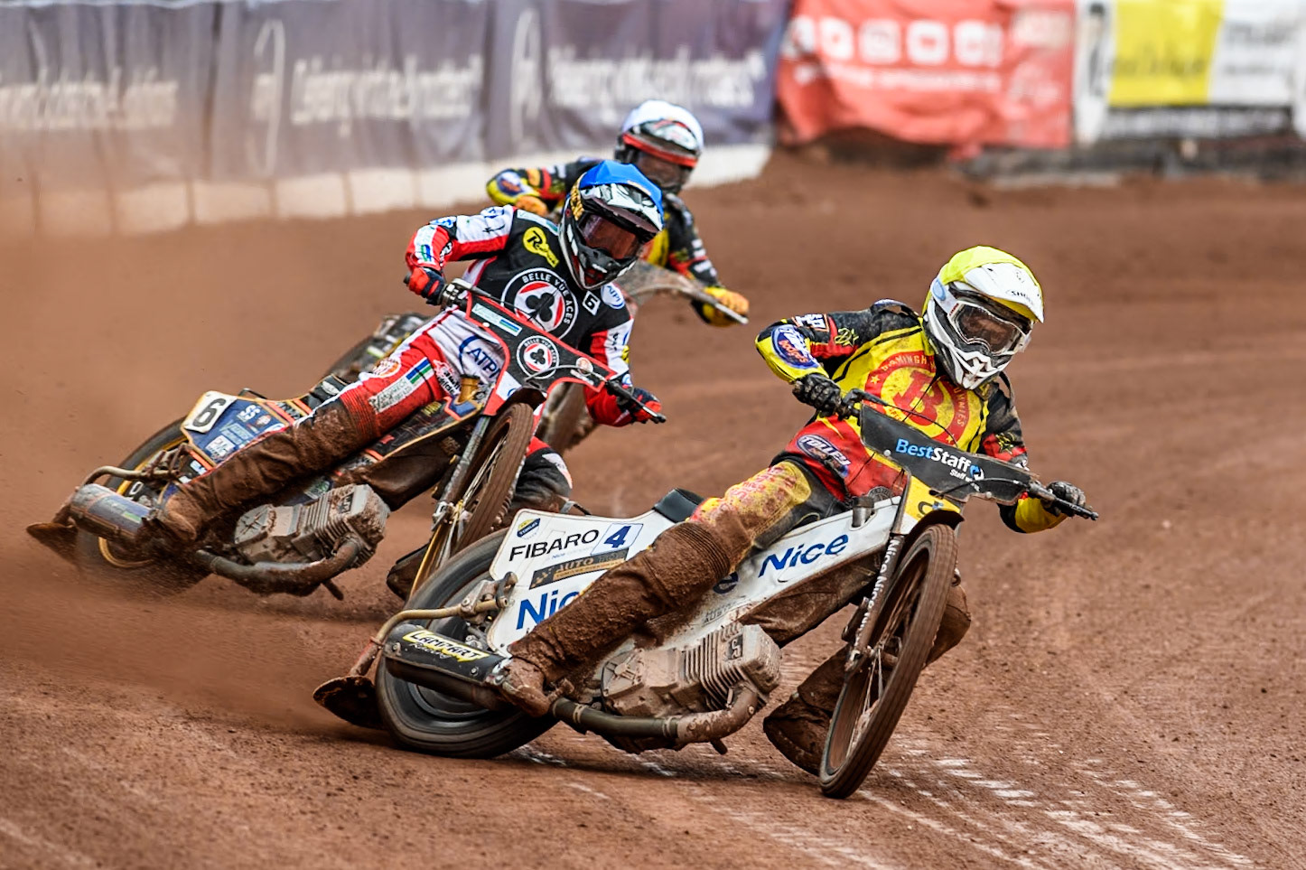 Birmingham Brummies' Wiktor Lampart  in Yellow leading Belle Vue Aces' Connor Mountain  in Blue and Birmingham Brummies' Leon Flint  in Yellow during the Rowe Motor Oil Premiership match between Belle Vue Aces and Birmingham Brummies at the National Speedway Stadium, Manchester on Monday 6th May 2024. (Photo: Ian Charles | MI News)