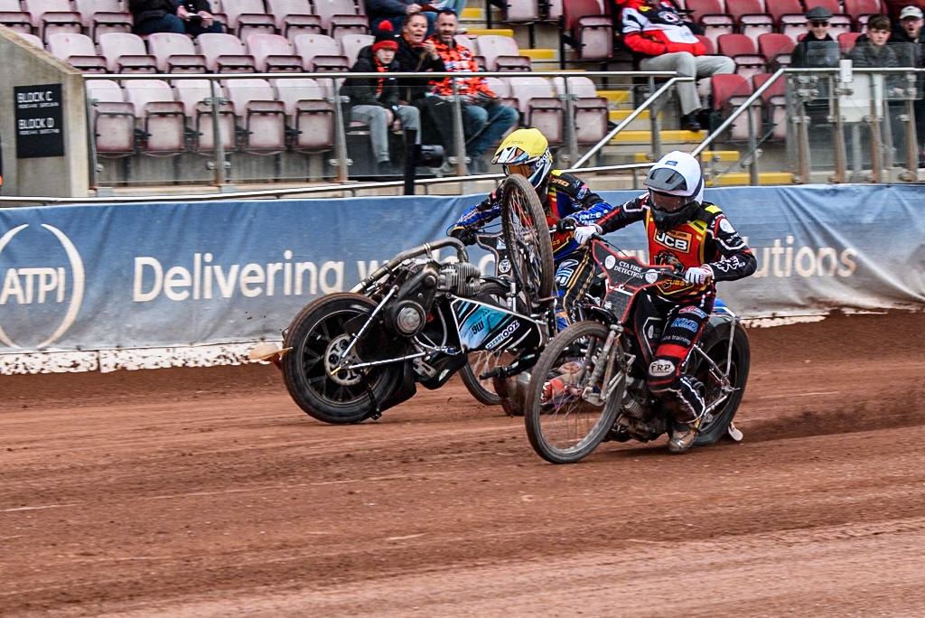 Belle Vue Colts' Harry Fletcher in Blue rears and falls between Leicester Lion Cubs' Guest Rider Ben Morley in White and Leicester Lion Cubs' Eli Meadows in Yellow during the WSRA National Development League match between Belle Vue Colts and Leicester Lion Cubs at the National Speedway Stadium, Manchester on Friday 18th April 2025. (Photo: Ian Charles | MI News)