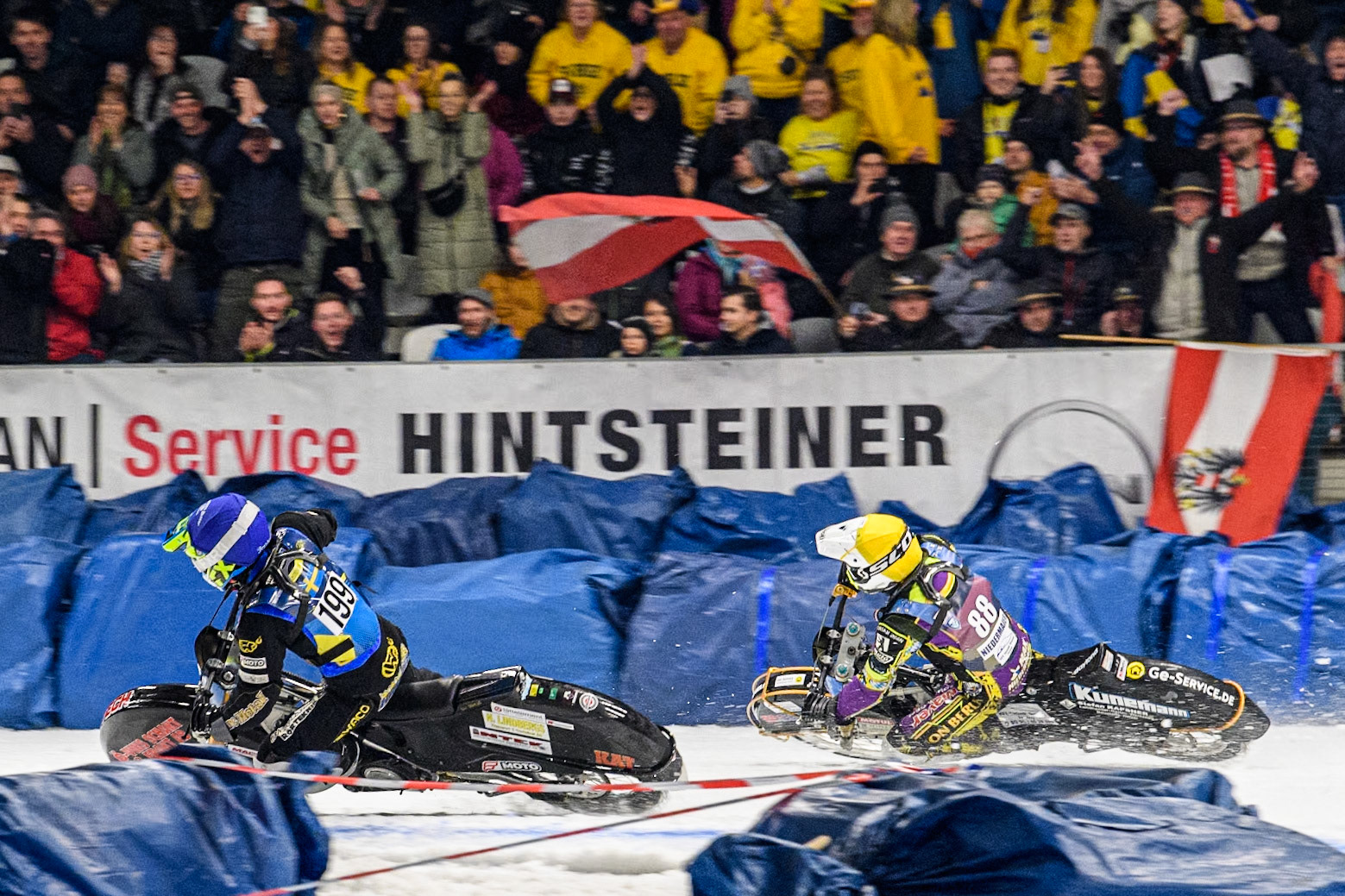 Germany's Max Niedermaier (88) (Yellow) chases Sweden's Martin Haarahiltunen (199)  (Blue) in the final during the FIM Ice Speedway Gladiators World Championship Final 1 at the Max-Aicher-Arena, Inzell on Saturday 23 March 2024. (Photo: Ian Charles | MI News)