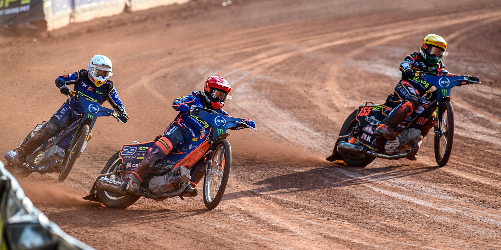 Andzejs Lebedevs (29) of Latvia in Red rides outside Mikkel Michelsen (155) of Denmark in Yellow with Robert Lambert (505) of Great Britain in White behind during the ATPI FIM Speedway Grand Prix Round 5 at the National Speedway Stadium, Manchester, on Saturday 14th June 2025. (Photo: Ian Charles | MI News)