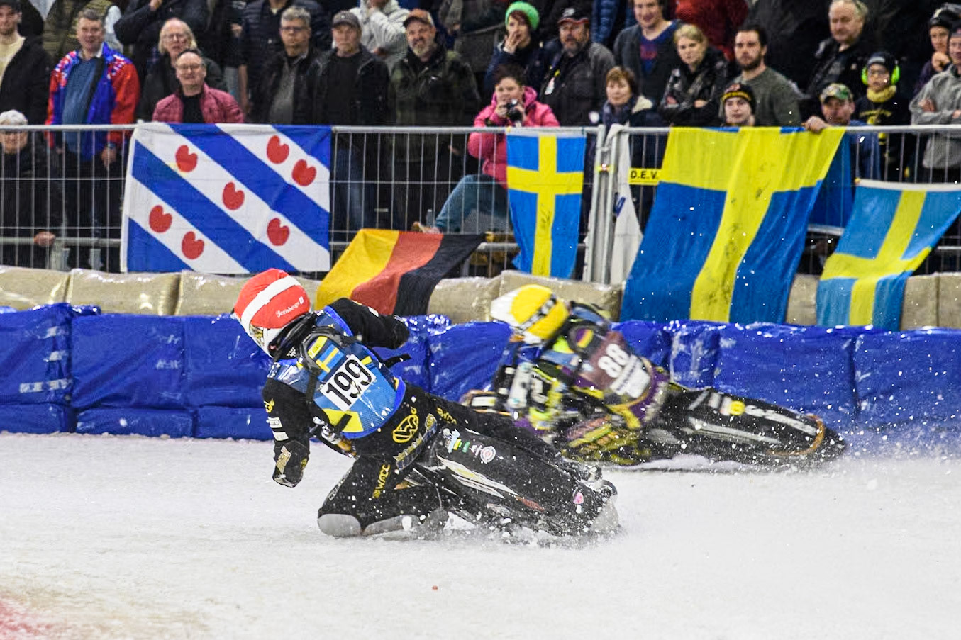Sweden's Martin Haarahiltunen (199)  in Red rides inside Germany's Max Niedermaier (88) in Yellow during the FIM Ice Speedway Gladiators World Championship Final 3 at Ice Rink Thialf, Heerenveen on Saturday 6th April 2024. (Photo: Ian Charles | MI News)
