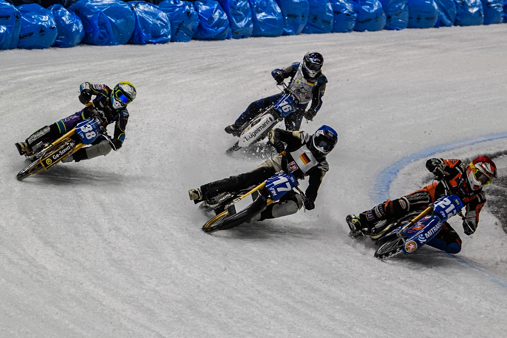 Lukas Hutla (212) of the Czech Republic in Red rides inside Reserve Franz Mayerbüchler (17) of Germany in Blue, and 38\ in Yellow with Wild Card Reinhard Greisel (16) of Germany behind during the Ice Speedway Gladiators World Championship Final 1 at Max-Aicher-Arena, Inzell on Saturday 15th March 2025. (Photo: Ian Charles | MI News)