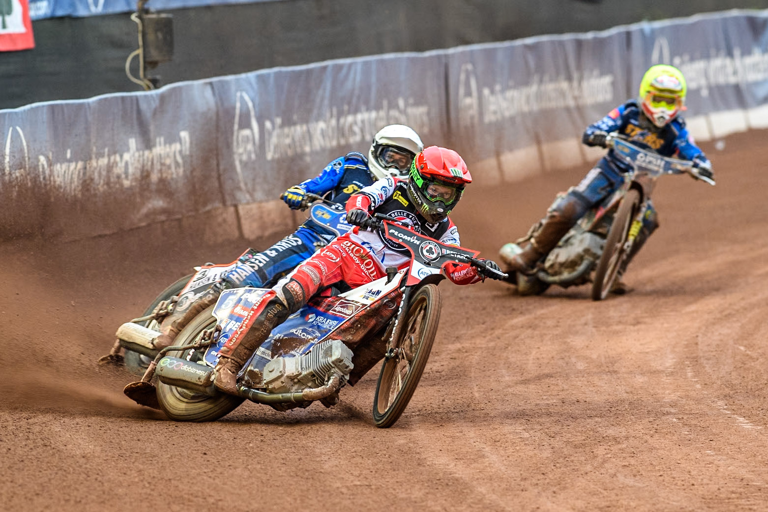 Belle Vue Aces' Dan Bewley in Red leading King Lynn Stars' Niels-Kristian Iversen in White and King Lynn Stars' Michael Palm Toft in Yellow during the Rowe Motor Oil Premiership match between Belle Vue Aces and King's Lynn Stars at the National Speedway Stadium, Manchester on Monday 20th May 2024. (Photo: Ian Charles | MI News)