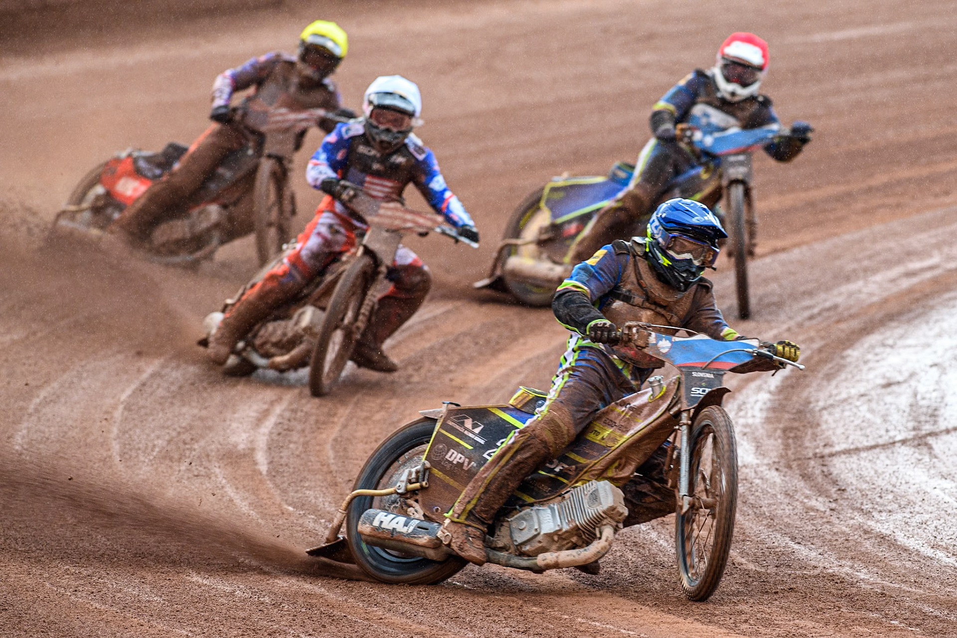 Matic Ivacic of Slovenia in Yellow leading Luke Becker of the USA in White, Anze Grmek of Slovenia in Red and  Gino Manzares of the USA in Yellow during the Monster Energy FIM Speedway of Nation Semi Final 2 at the National Speedway Stadium, Manchester on Wednesday 10th July 2024. (Photo: Ian Charles | MI News)