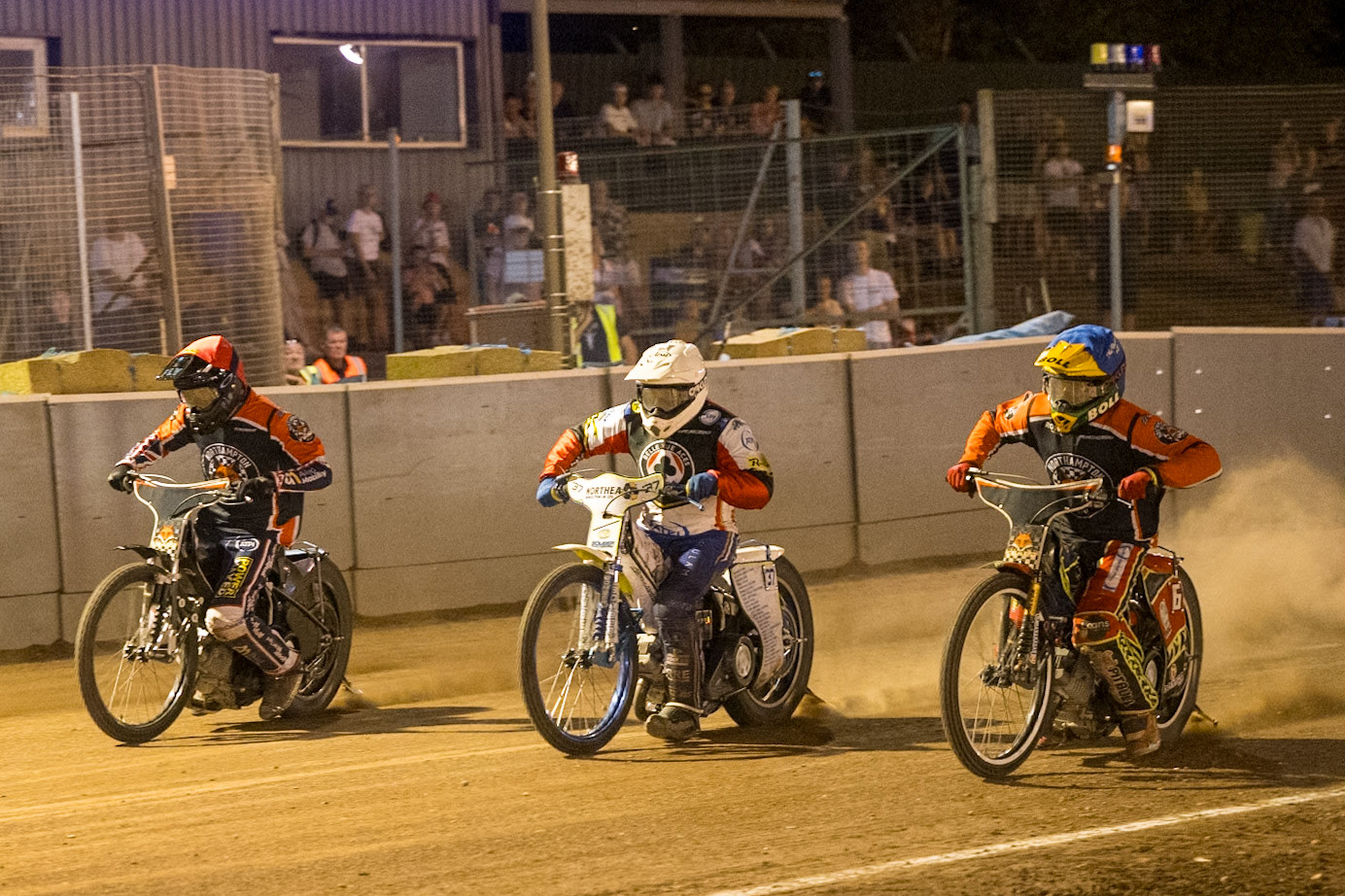(L to R) Adam Ellis of Northampton Foxes  in Red , Chris Harris Guest Rider for Belle Vue Aces in White  and Mitch McDiarmid of Northampton Foxes in Blue leave the start during the Rowe Motor Oil Premiership match between Northampton Foxes and Belle Vue Aces at Northampton International Shaleway, Northampton on Thursday 13th August 2026. (Photo: Ian Charles | MI News)