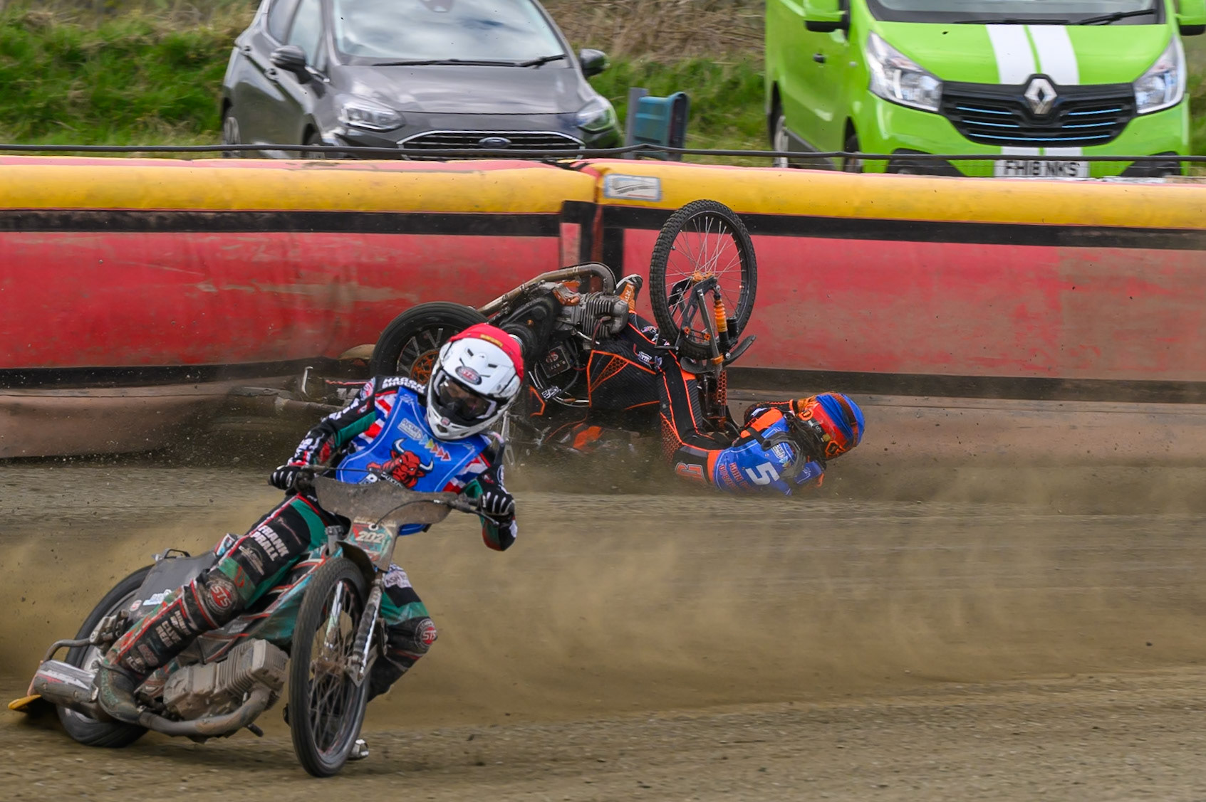 Connor Coles of NDL Nomads   in White fall and Jack Smith of Buxton Bulls   in Blue collides with him during the  Challenge match between Buxton Bulls and NDL Nomads at Hi-Edge Speedway, Buxton on Sunday 19th April 2026. (Photo: Ian Charles | MI News)