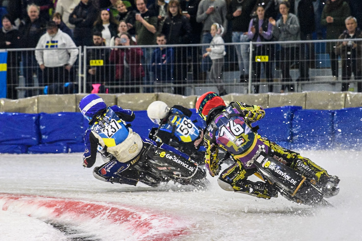 Germany's Maximillian Neidermaier (16) in Red chases Sweden's Jimmy Hörnell Lidfalk (237) in Blue and Sweden's Stefan Svensson (58) in White during the FIM Ice Speedway Gladiators World Championship Final 4 at Ice Rink Thialf, Heerenveen on Sunday 7th April 2024. (Photo: Ian Charles | MI News)