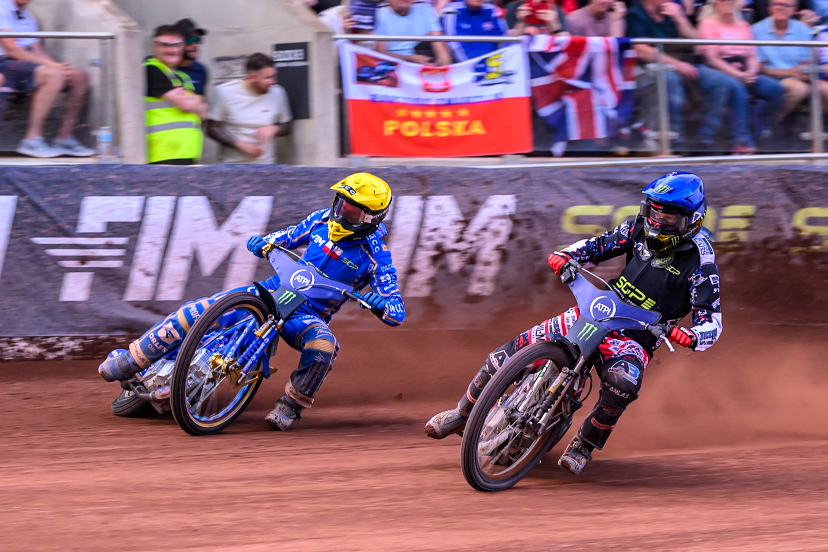 Fredrik Lindgren (66) of Sweden in Blue rides inside Bartosz Zmarzlik (95) of Poland in Yellow during the ATPI FIM Speedway Grand Prix Round 4 at the National Speedway Stadium, Manchester, on Friday 13th June 2025. (Photo: Ian Charles | MI News)