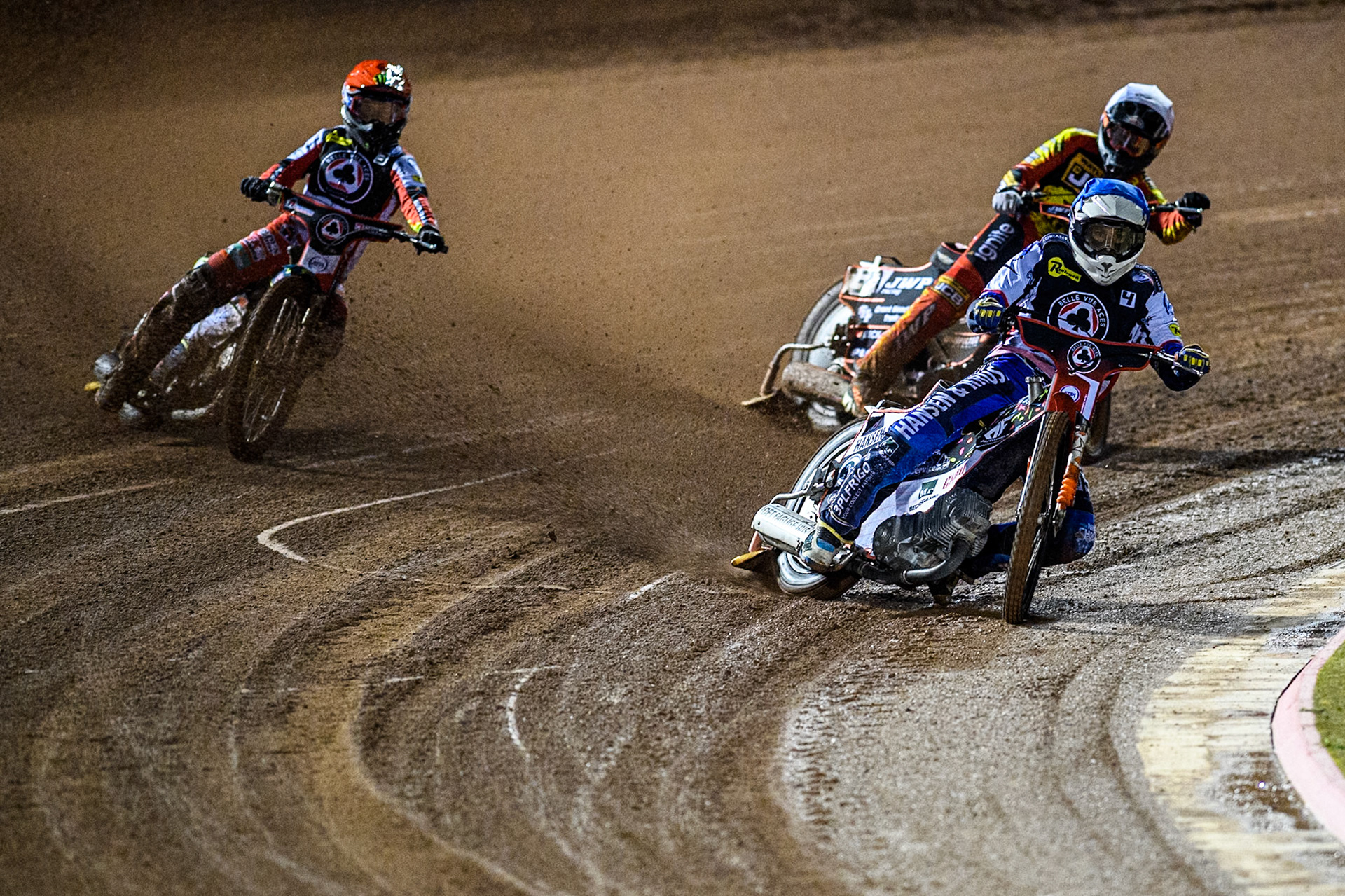 Belle Vue Aces' Guest Rider Niels. K. Iversen  in Blue leading Leicester Lions' Sam Masters  in White and Belle Vue Aces' Jaimon Lidsey  in Red during the Rowe Motor Oil Premiership Grand Final 1st Leg between Belle Vue Aces and Leicester Lions at the National Speedway Stadium, Manchester on Monday 23rd September 2024. (Photo: Ian Charles | MI News)
