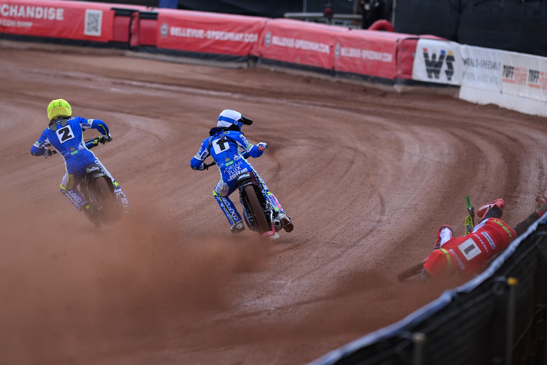 Belle Vue Colts' William Cairns falls whilst trying to pass Oxford Chargers' Jody Scott  in White and Oxford Chargers' Jacob Clouting  in Yellow during the WSRA National Development League match between Belle Vue Colts and Oxford Chargers at the National Speedway Stadium, Manchester on Sunday 1st June 2025. (Photo: Ian Charles | MI News)