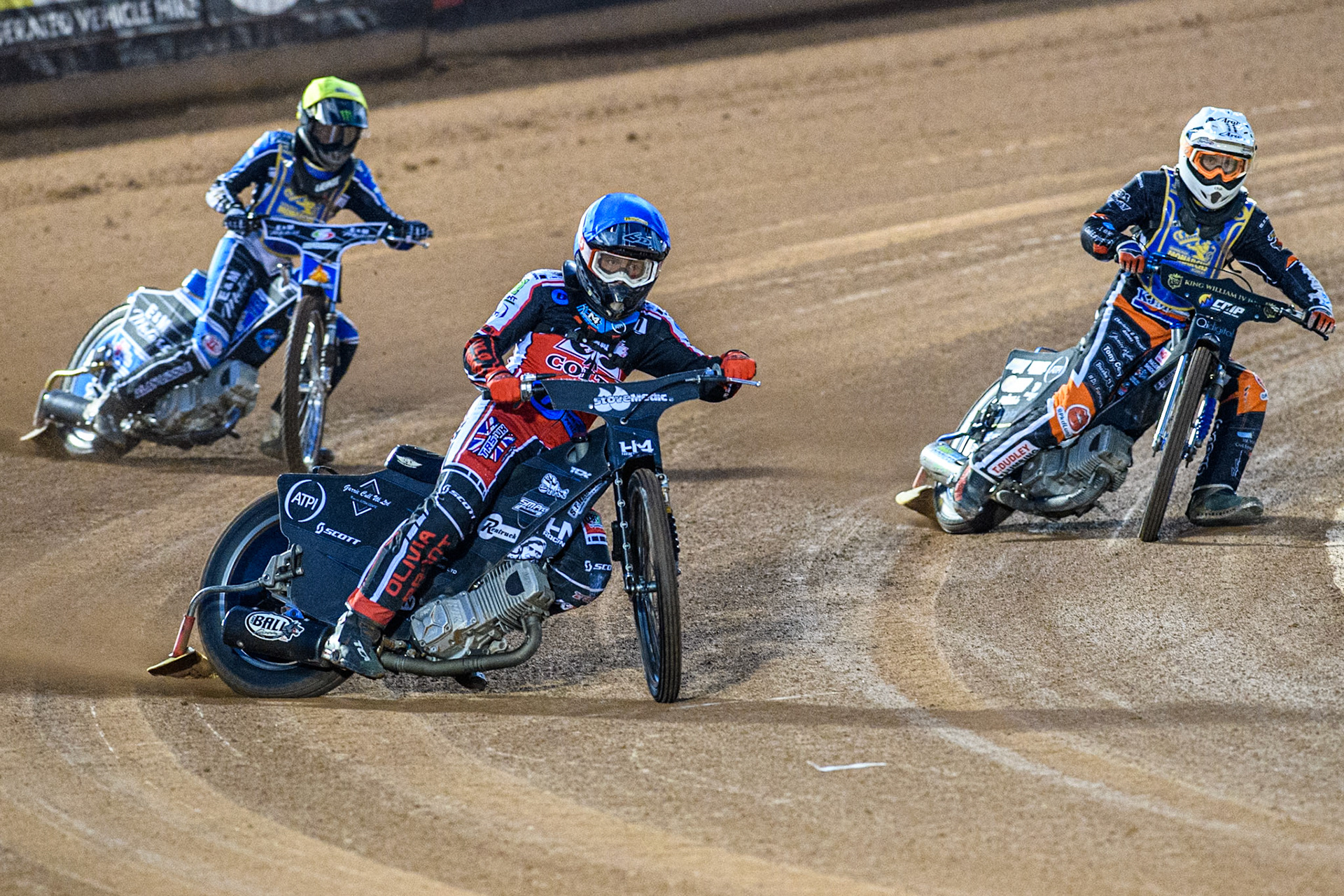 Belle Vue Colts' Harry McGurk in Blue leading Edinburgh Monarchs' Mark Parker in White and Edinburgh Monarchs' Guest Rider Lee Harrison in Yellow during the WSRA National Development League match between Belle Vue Aces and Edinburgh Monarchs at the National Speedway Stadium, Manchester on Friday 30th August 2024. (Photo: Ian Charles | MI News)