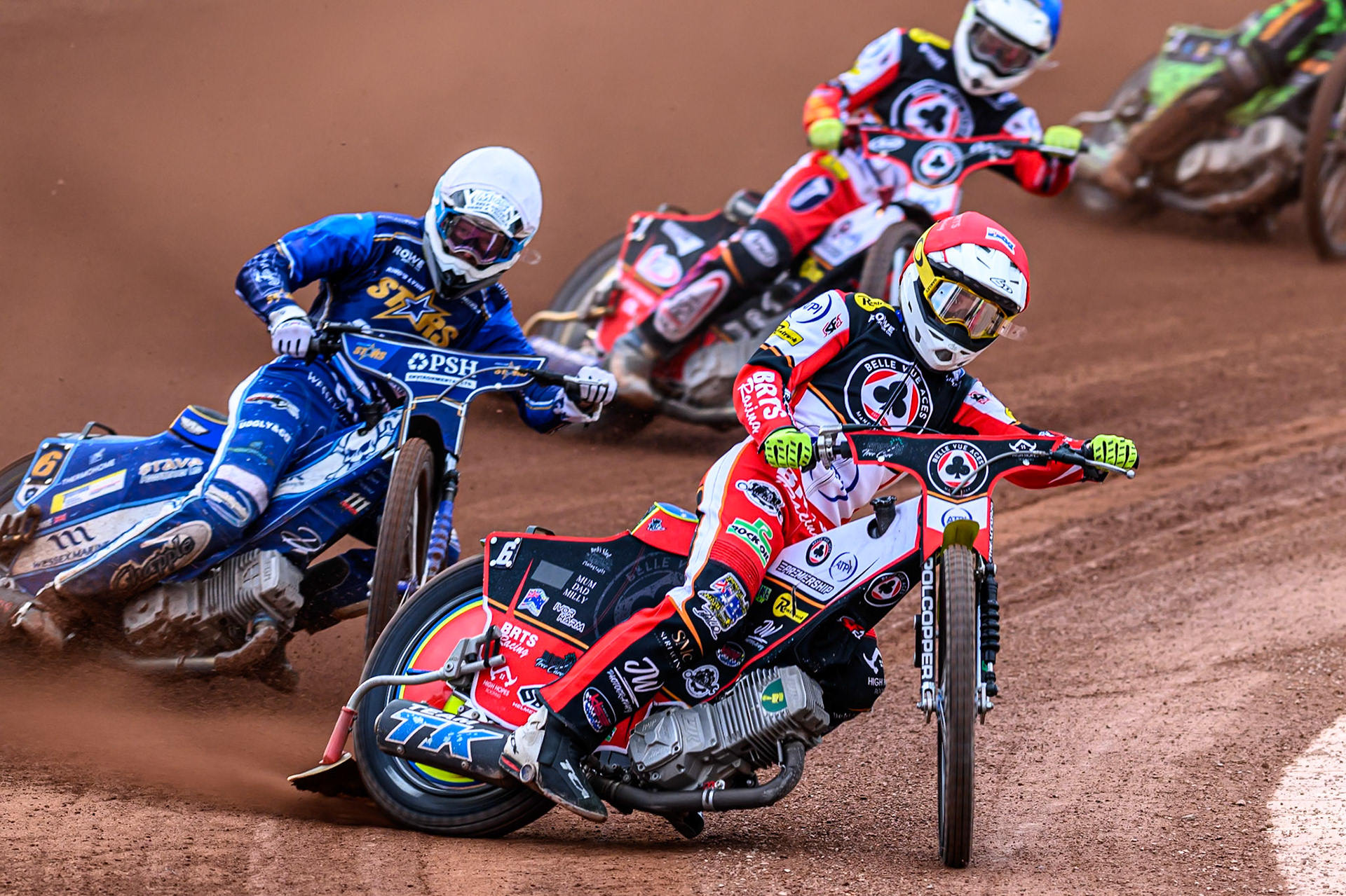 Belle Vue Aces' Tate Zischke in Red leading Kings Lynn Stars' Guest Rider, Anders Rowe in White and Belle Vue Aces' Jake Mulford in Blue during the Rowe Motor Oil Premiership match between Belle Vue Aces and King's Lynn Stars at the National Speedway Stadium, Manchester on Monday 23rd June 2025. (Photo: Ian Charles | MI News)