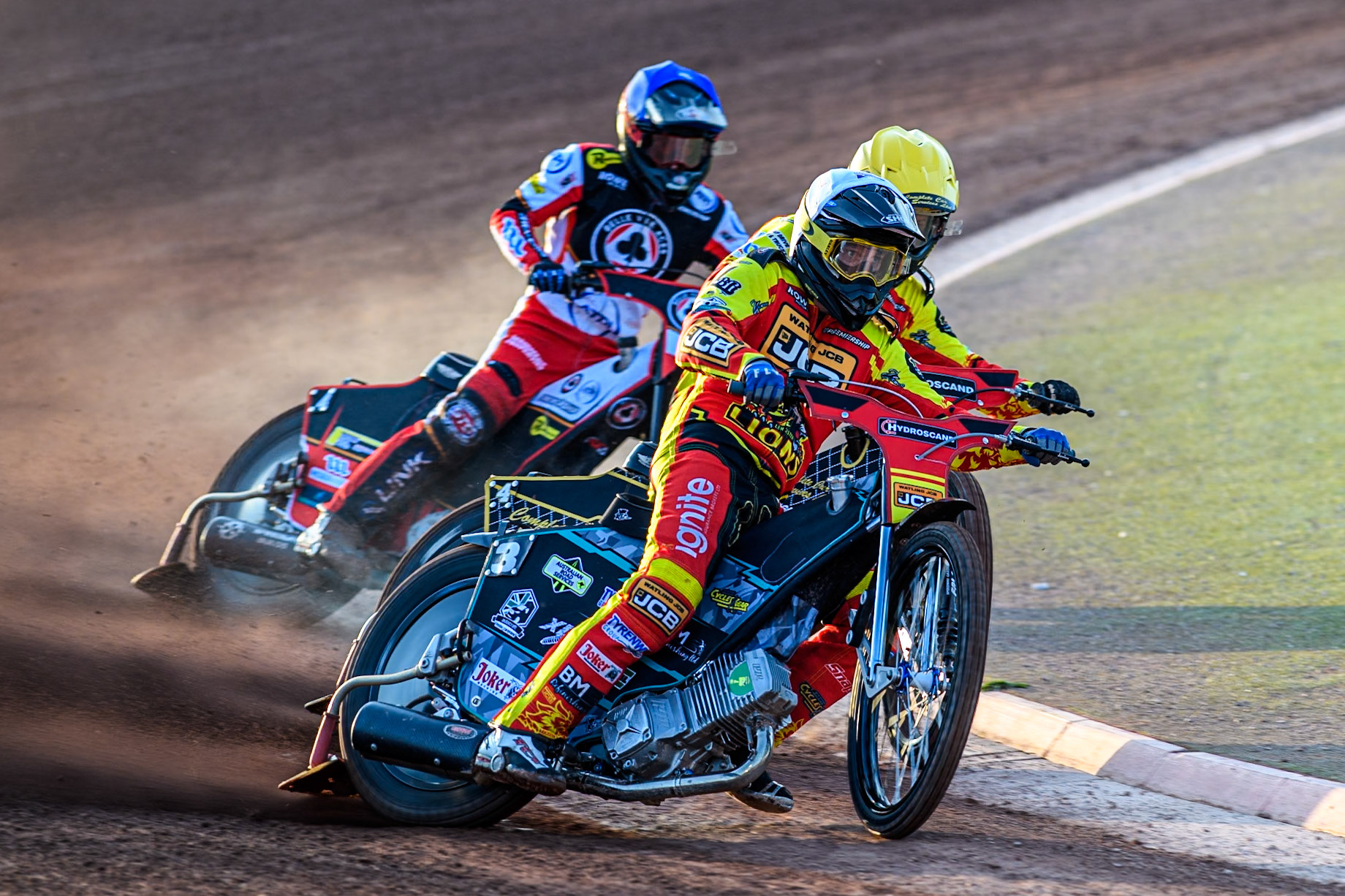 Leicester Lions' Ryan Douglas in White leading Leicester Lions' Kyle Howarth in Yellow and Belle Vue Aces' Zach Cook in Blue during the Rowe Motor Oil Premiership match between Belle Vue Aces and Leicester Lions at the National Speedway Stadium, Manchester on Monday 19th May 2025. (Photo: Ian Charles | MI News)