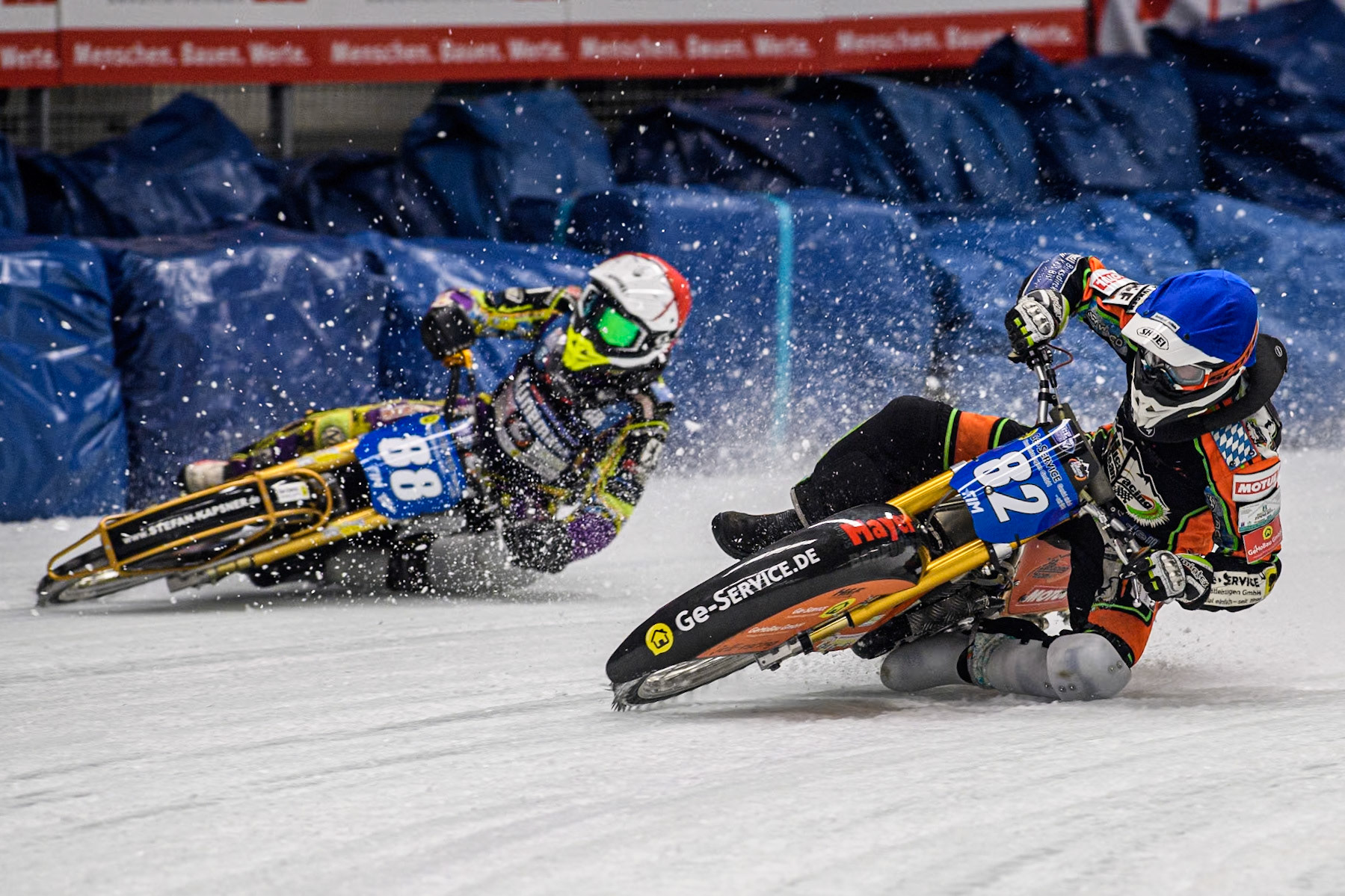 Germany's Markus Jell (82) (Blue) leads  Germany's Max Niedermaier (88) (Red) during the FIM Ice Speedway Gladiators World Championship Final 1 at the Max-Aicher-Arena, Inzell on Saturday 23 March 2024. (Photo: Ian Charles | MI News)