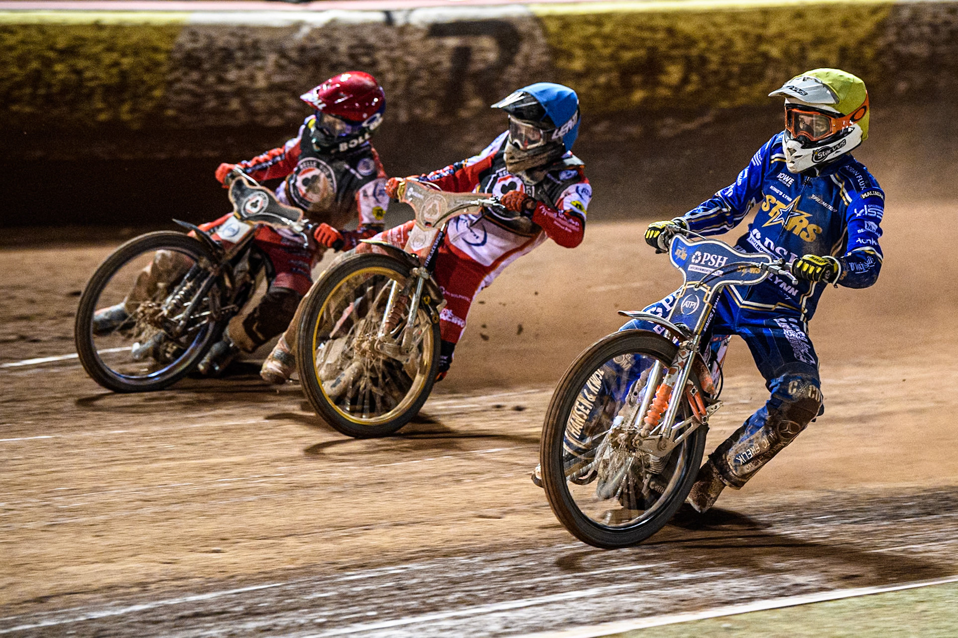 Niels-Kristian Iversen of Kings Lynn Stars in Yellow rides inside Norick Blödorn of Belle Vue Aces in Blue and Brady Kurtz of Belle Vue Aces in Red during the Rowe Motor Oil Premiership match between Belle Vue Aces and King's Lynn Stars at the National Speedway Stadium, Manchester on Monday 5th April 2025. (Photo: Ian Charles | MI News)