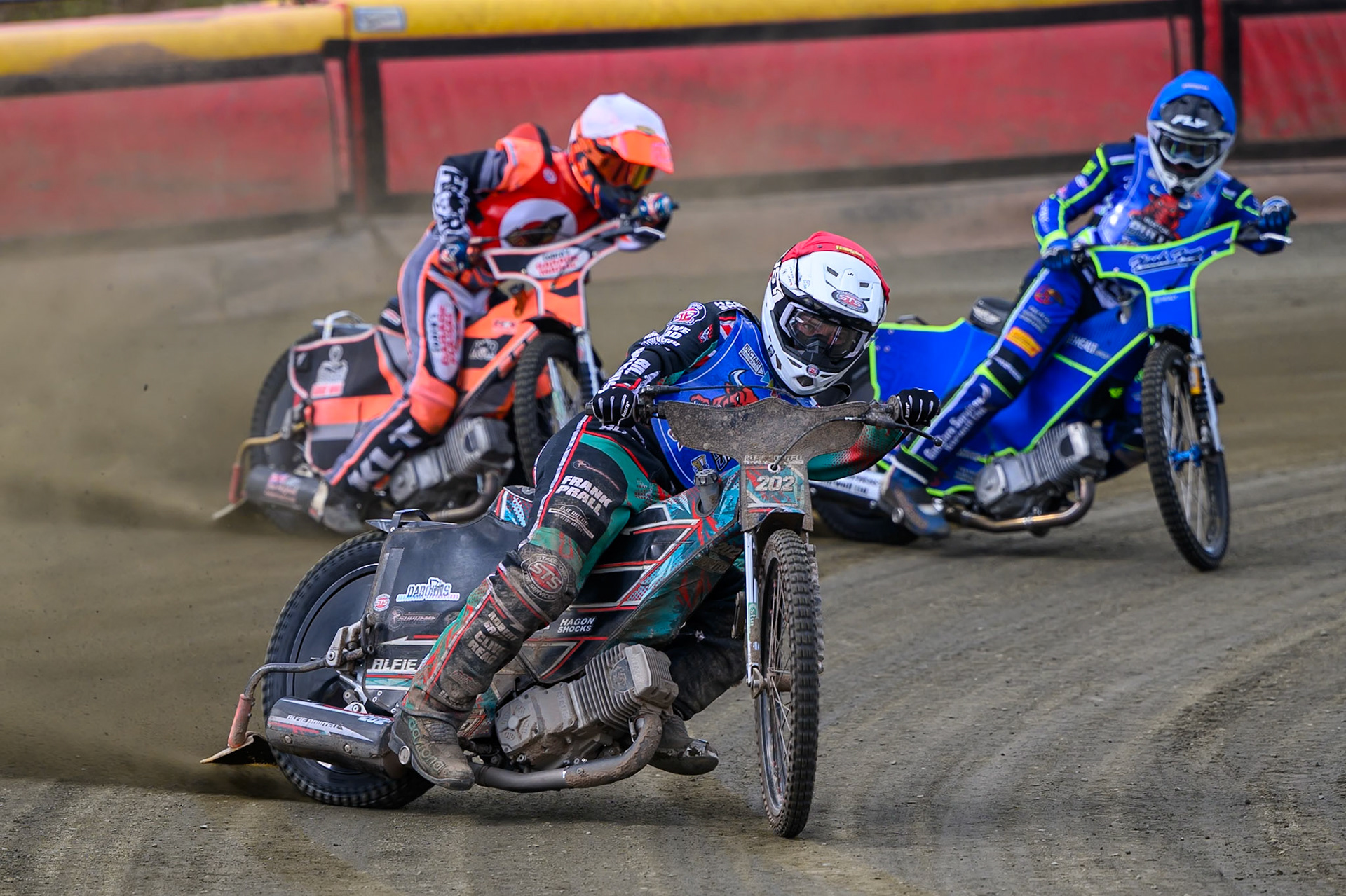 Alfie Bowtell of Buxton Bulls  in Red leading Connor Coles of NDL Nomads   in White and Arran Butcher of Buxton Bulls  in Blue during the  Challenge match between Buxton Bulls and NDL Nomads at Hi-Edge Speedway, Buxton on Sunday 19th April 2026. (Photo: Ian Charles | MI News)