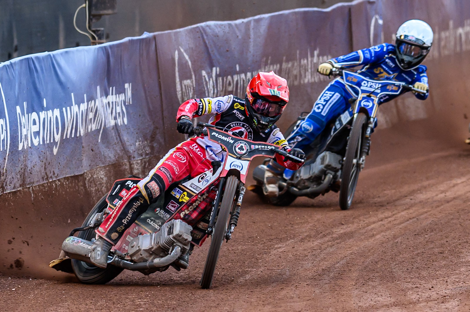 Belle Vue Aces' Dan Bewley in Red leading Kings Lynn Stars' Nicolai Klindt in White during the Rowe Motor Oil Premiership match between Belle Vue Aces and King's Lynn Stars at the National Speedway Stadium, Manchester on Monday 23rd June 2025. (Photo: Ian Charles | MI News)