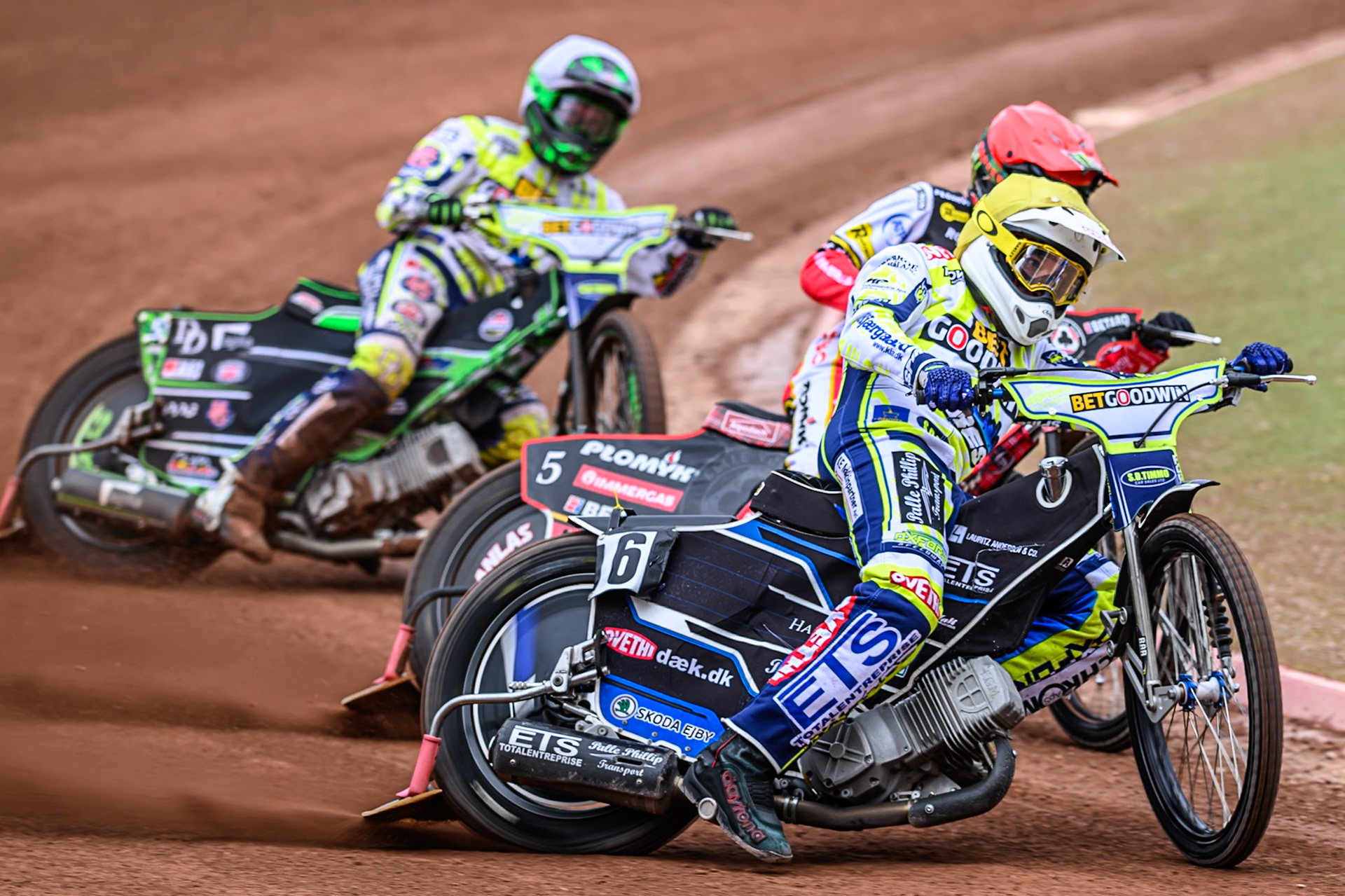 Oxford Spires' Peter Kildemand in Yellow leading Belle Vue Aces' Dan Bewley in Red and Oxford Spires' Charles Wright in White during the Rowe Motor Oil Premiership match between Belle Vue Aces and Oxford Spires at the National Speedway Stadium, Manchester on Monday 26th May 2025. (Photo: Ian Charles | MI News)