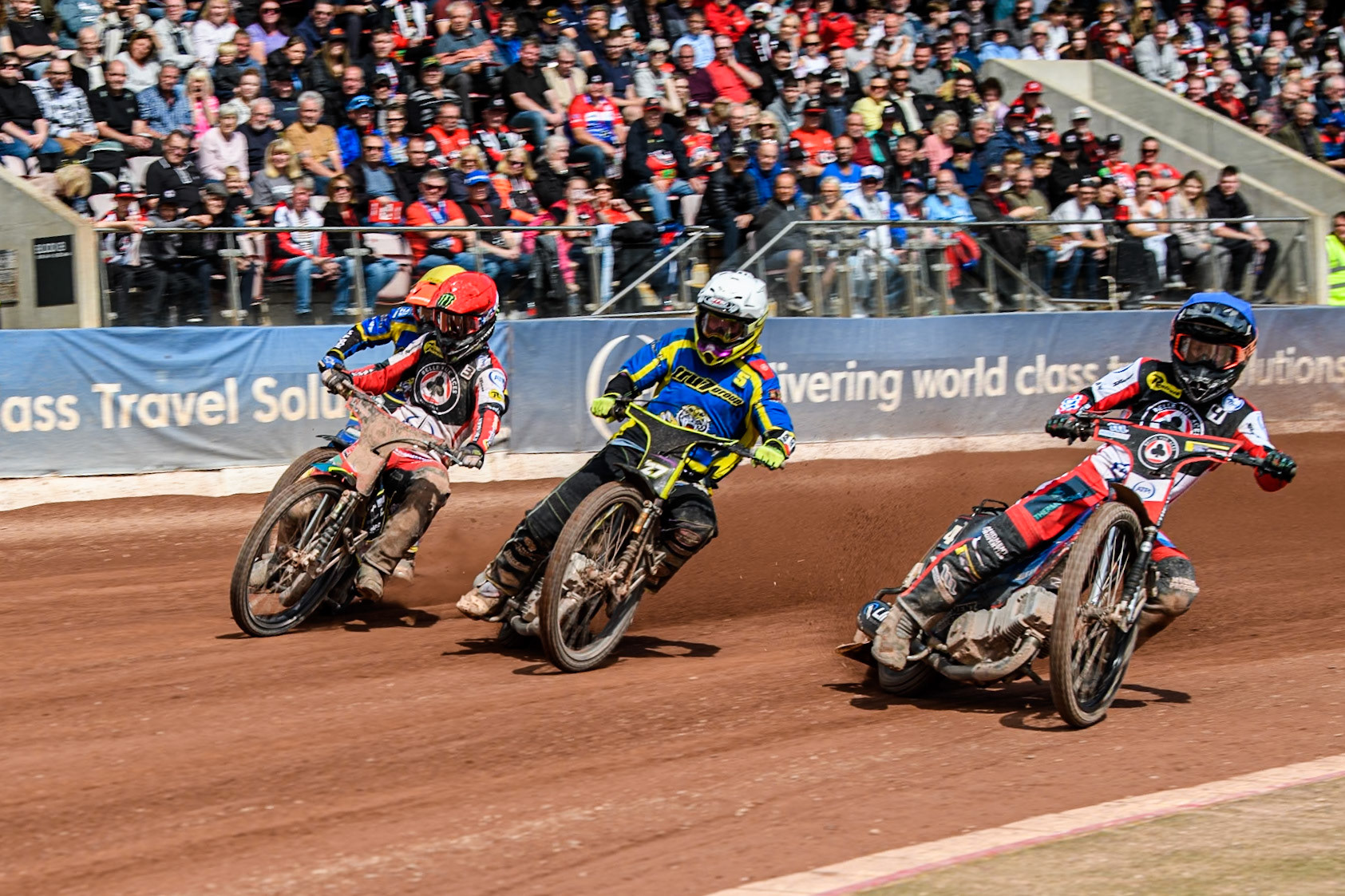 Belle Vue Aces' Ben Cook  in Blue rides inside Sheffield Tigers' Guest Rider Tom Brennan  in White and Belle Vue Aces' Jaimon Lidsey  in Red with Sheffield Tigers' Jason Edwards  in Yellow behind during the Rowe Motor Oil Premiership match between Belle Vue Aces and Sheffield Tigers at the National Speedway Stadium, Manchester on Monday 26th August 2024. (Photo: Ian Charles | MI News)