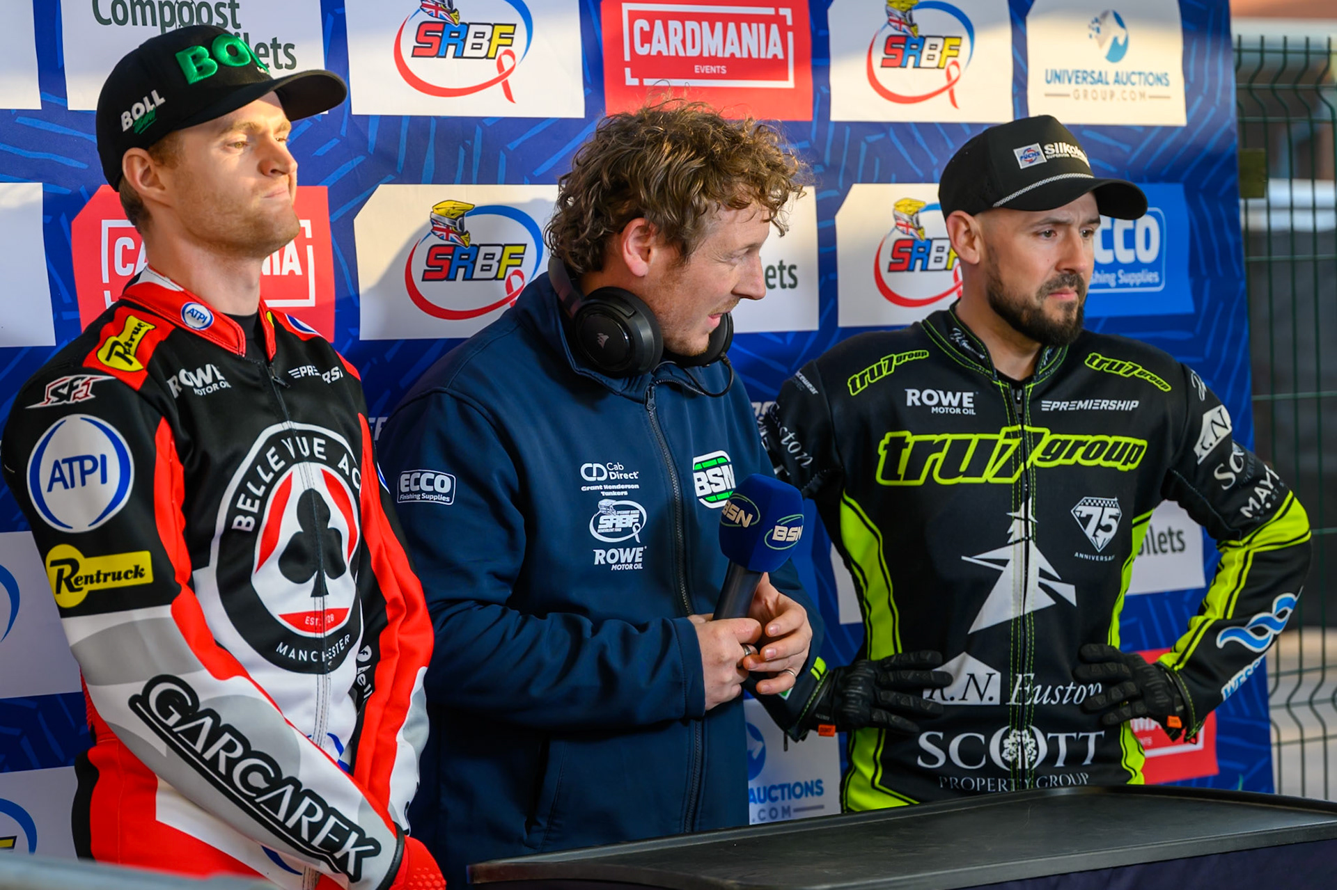 (L to R) Brady Kurtz of Belle Vue Aces, BSN Presenter Greg Blair, Danny King of Ipswich Witches during the Rowe Motor Oil Premiership match between Belle Vue Aces and Ipswich Witches at the National Speedway Stadium, Manchester on Monday 20th April 2026. (Photo: Ian Charles | MI News)