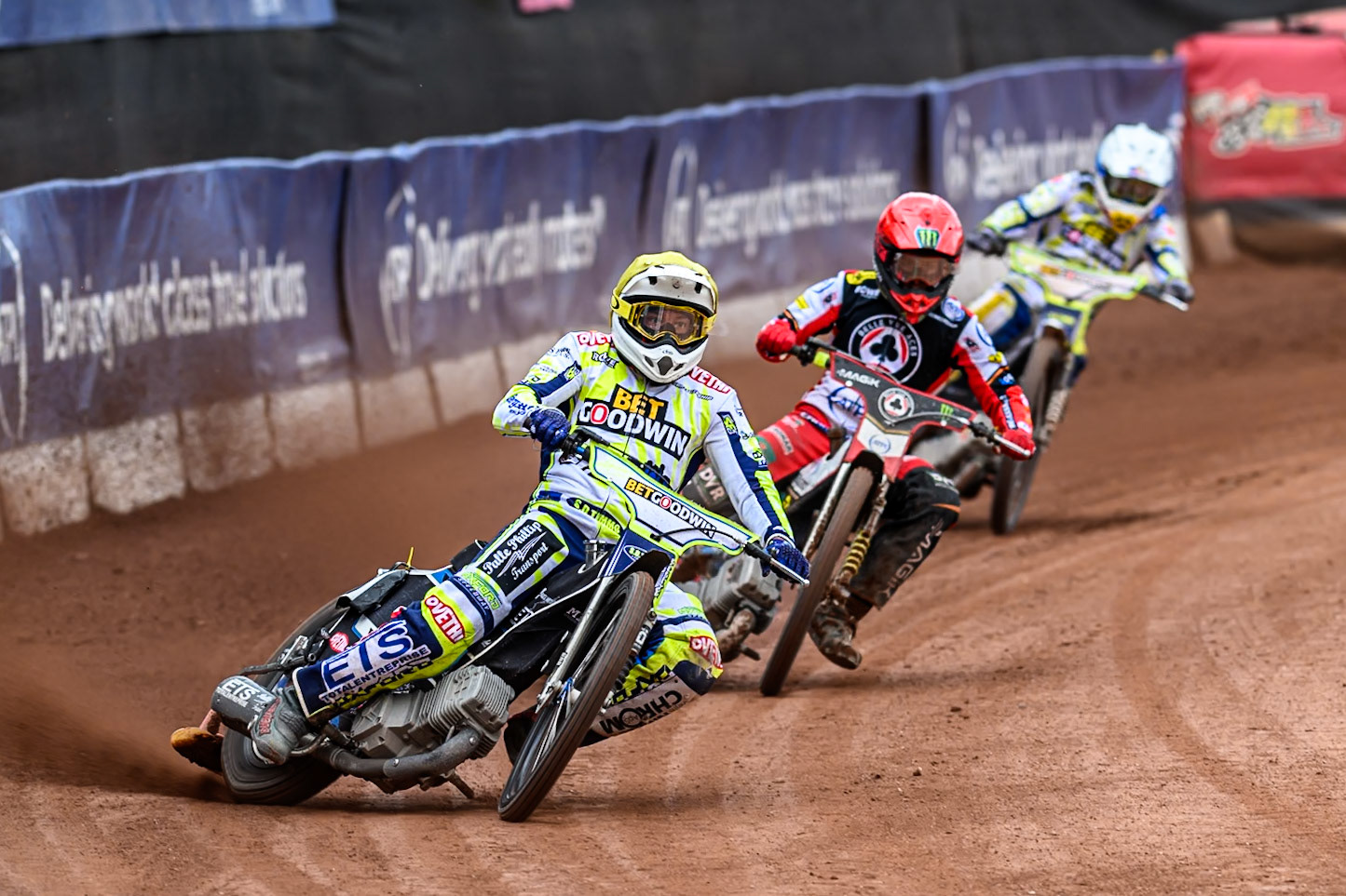 Oxford Spires' Peter Kildemand in Yellow leading Belle Vue Aces' Jaimon Lidsey in Red and Oxford Spires' Maciej Janowski in White during the Rowe Motor Oil Premiership match between Belle Vue Aces and Oxford Spires at the National Speedway Stadium, Manchester on Monday 26th May 2025. (Photo: Ian Charles | MI News)