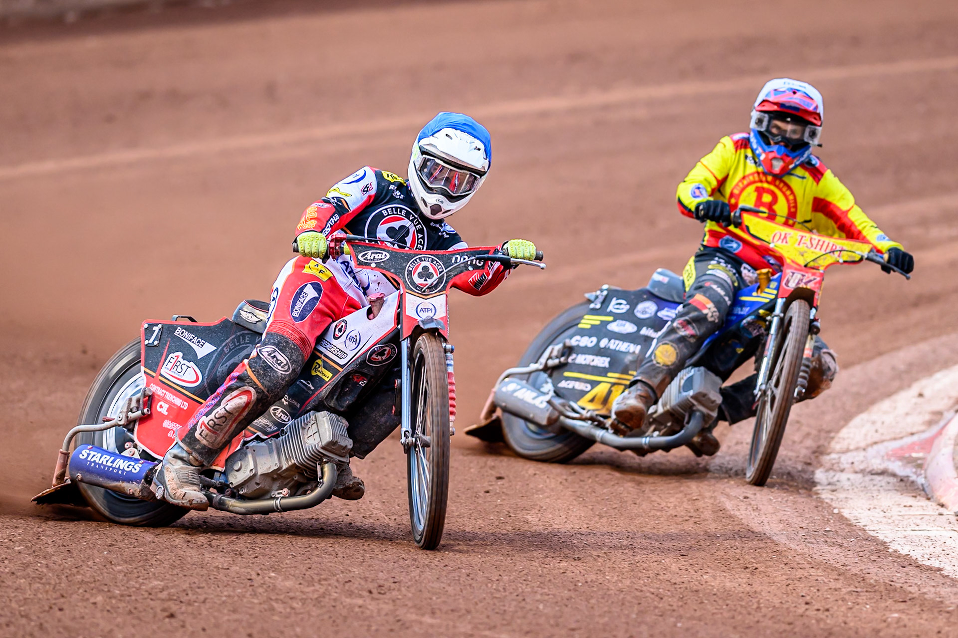 Belle Vue Aces' Jake Mulford  in Blue rides outside Birmingham Brummies' Paco Castagna  in White during the Rowe Motor Oil Premiership match between Belle Vue Aces and Birmingham Brummies at the National Speedway Stadium, Manchester on Monday 7th July 2025. (Photo: Ian Charles | MI News)