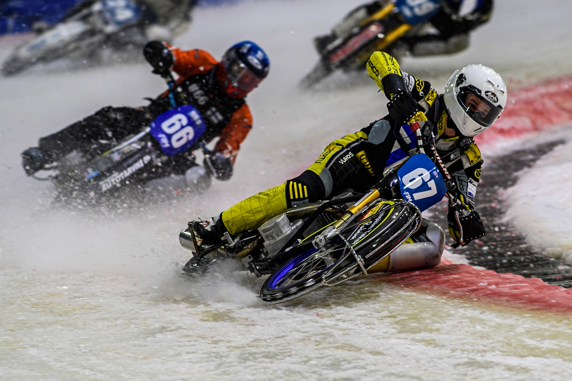 Finland's Heikki Huusko (67) in White leading Finland's Aki Ala-Riihimäki (66) in Blue during the FIM Ice Speedway Gladiators World Championship Final 3 at Ice Rink Thialf, Heerenveen on Saturday 6th April 2024. (Photo: Ian Charles | MI News)