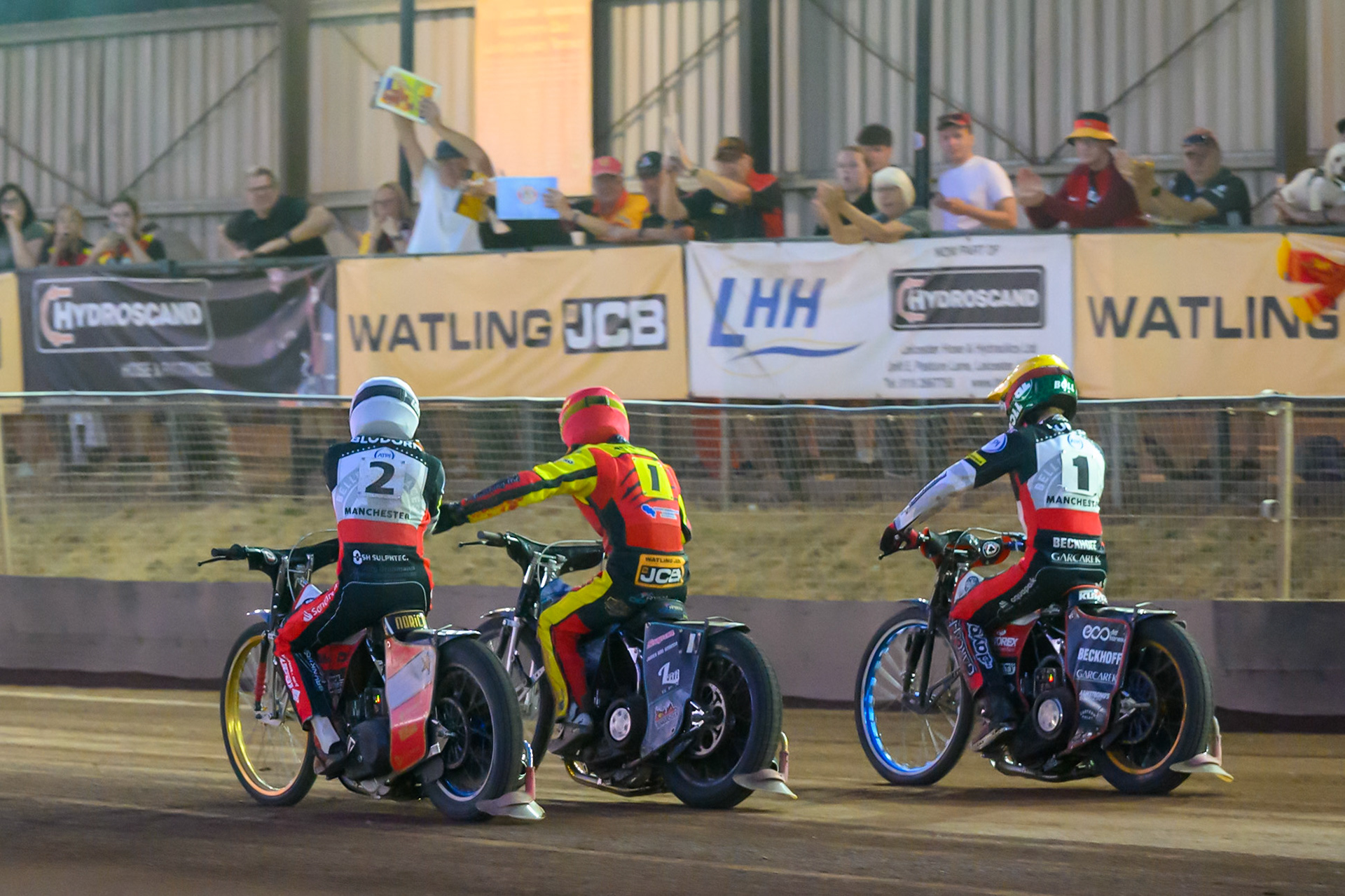Norick Blodorn of Belle Vue Aces  in White congratulates Ryan Douglas of Leicester Lions in Red after the final heat with Brady Kurtz of Belle Vue Aces in White  on the outside during the Rowe Motor Oil Premiership match between Leicester Lions and Belle Vue Aces at the Hydroscan Arena, Leicester on Thursday 23rd July 2026. (Photo: Ian Charles | MI News)