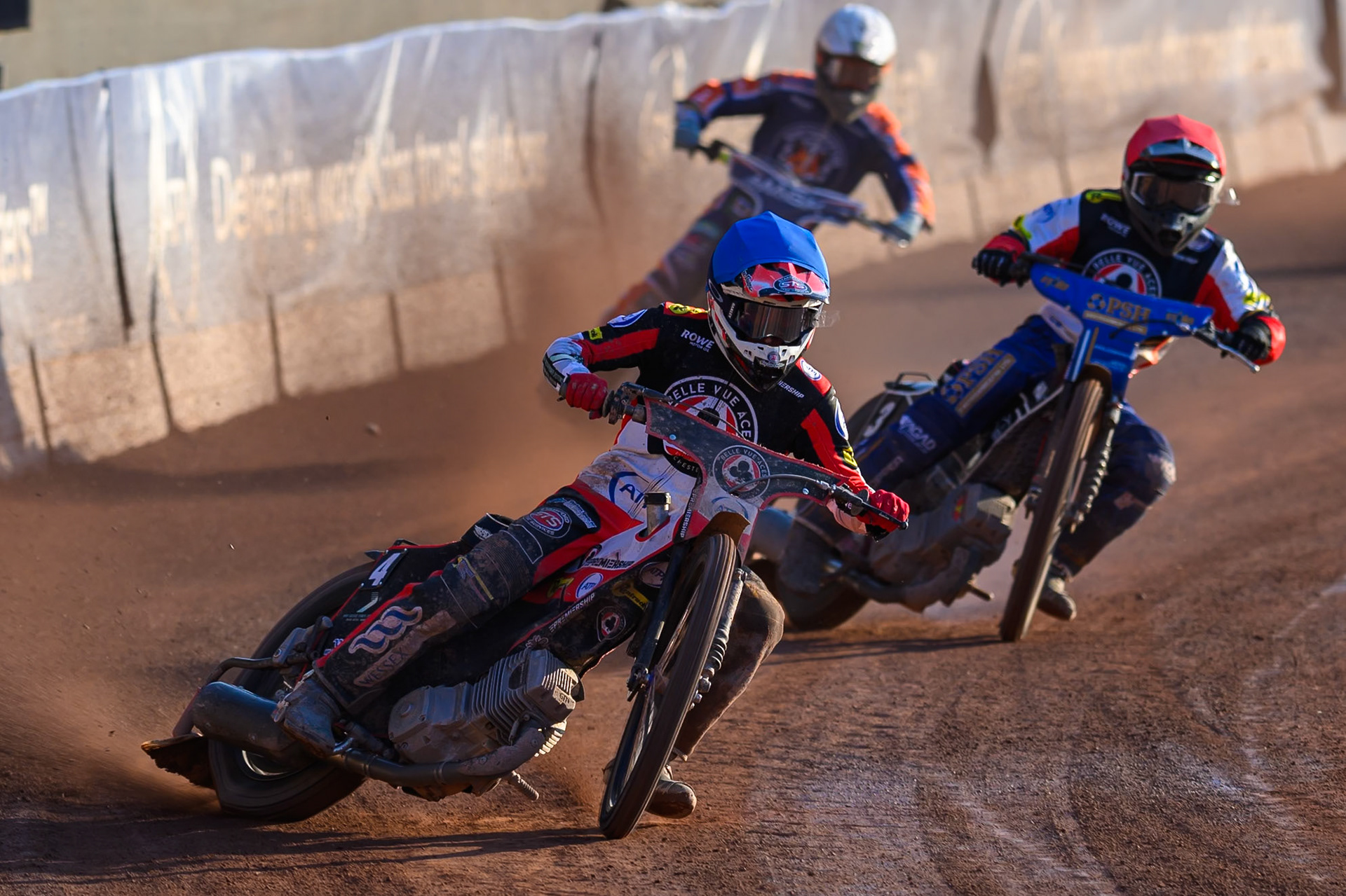 Zach Cook of Belle Vue Aces  in Blue leading Ben Cook, Guest Rider for Belle Vue Aces in Red andJaimon Lidsey of Northampton Foxes  in White during the Rowe Motor Oil Premiership match between Belle Vue Aces and Northampton Foxes at the National Speedway Stadium, Manchester on Monday 13th July 2026. (Photo: Ian Charles | MI News)