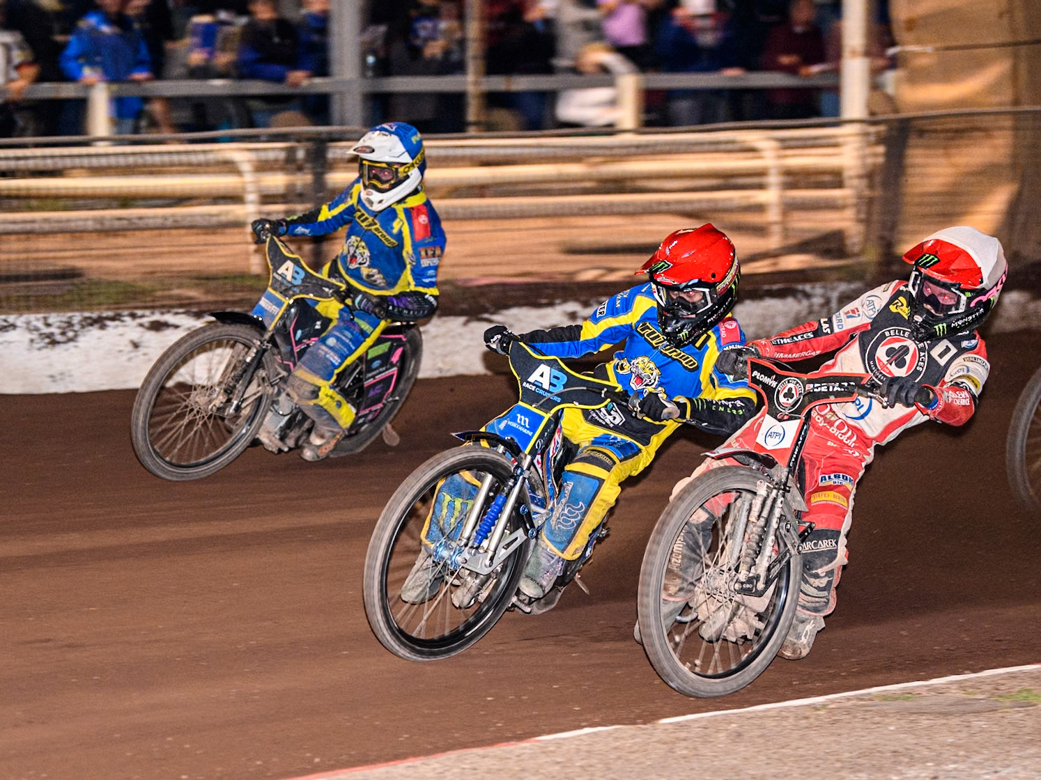 Belle Vue Aces' Dan Bewley   in White rides inside Sheffield Tigers' Jack Holder  in Red and Sheffield Tigers' Josh Pickering  in Blue during the Rowe Motor Oil Premiership match between Sheffield Tigers and Belle Vue Aces at Owlerton Stadium, Sheffield on Monday 26th August 2024. (Photo: Ian Charles | MI News)