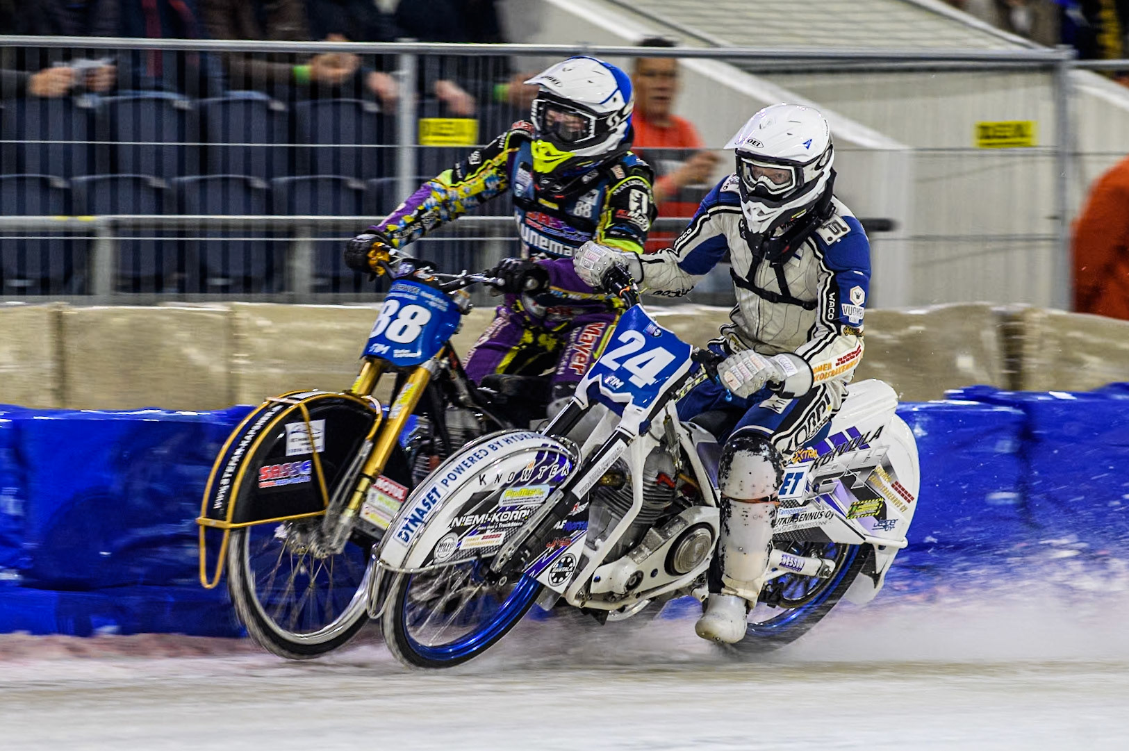 Finland's Max Koivula (24) in White battles with Germany's Max Niedermaier (88) in Blue during the FIM Ice Speedway Gladiators World Championship Final 3 at Ice Rink Thialf, Heerenveen on Saturday 6th April 2024. (Photo: Ian Charles | MI News)