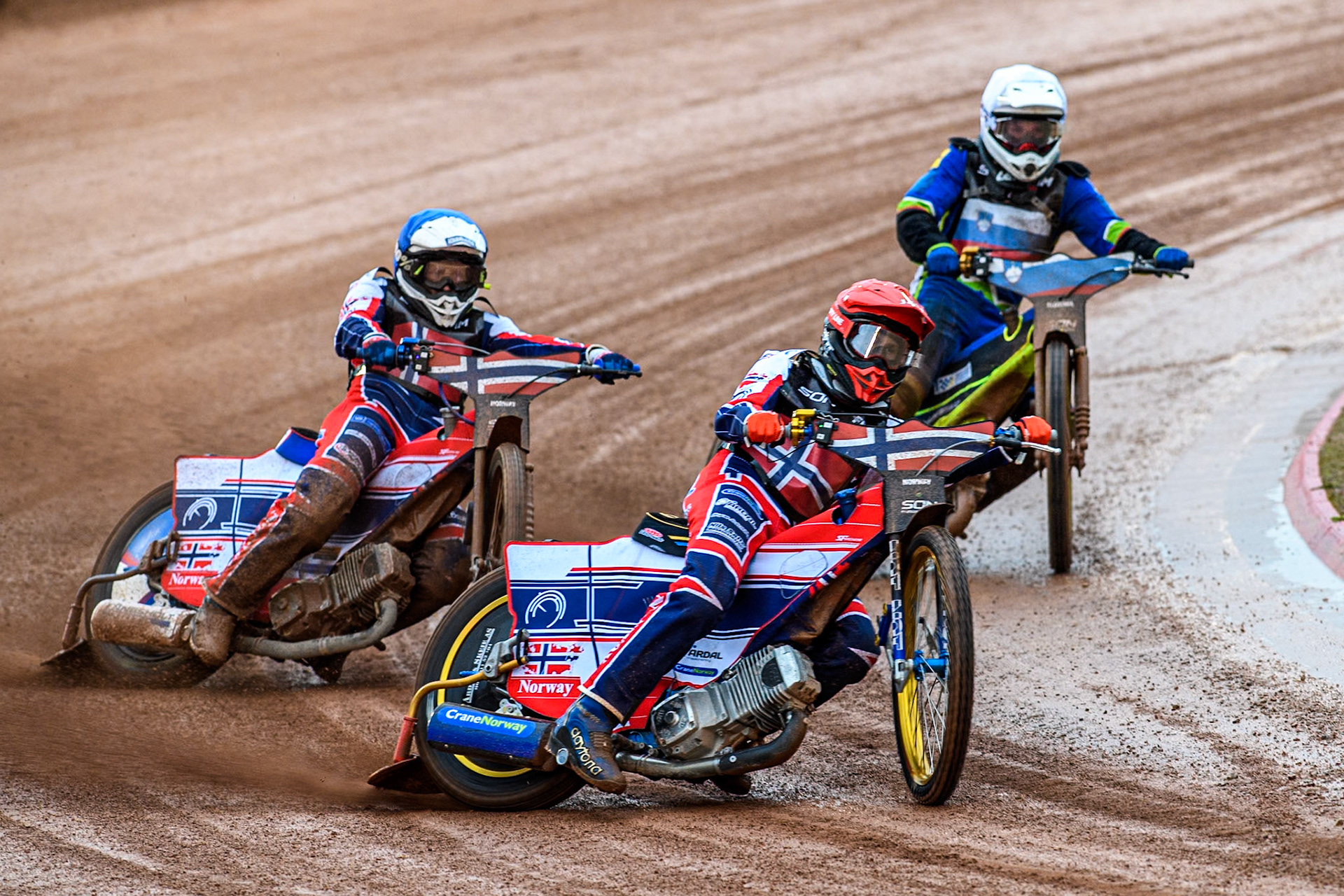 Norway v Slovenia : Mathias Pollestad of Norway in Red leading Truls Kamhaug of Norway in Blue and Anze Grmek of Slovenia in White during the Monster Energy FIM Speedway of Nation Semi Final 2 at the National Speedway Stadium, Manchester on Wednesday 10th July 2024. (Photo: Ian Charles | MI News)
