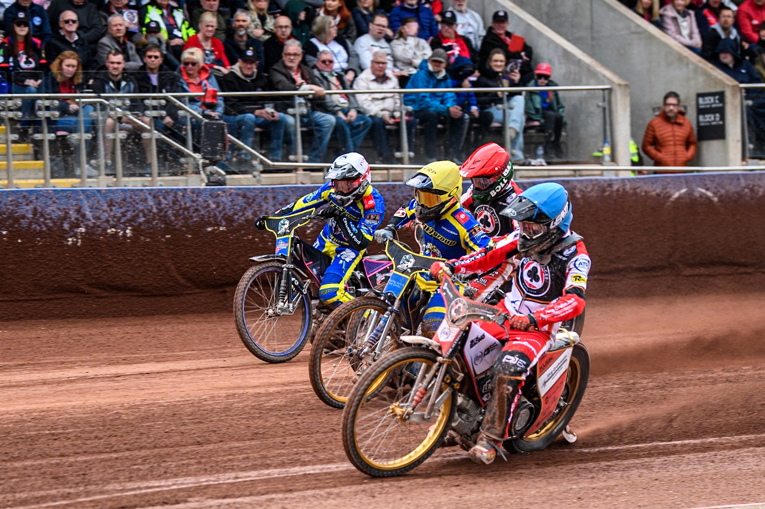 Norick Blödorn of Belle Vue Aces in Blue rides inside Justin Sedgmen of Sheffield Tigers in Yellow, Brady Kurtz of Belle Vue Aces in Red and Josh Pickering of Sheffield Tigers in White during the Rowe Motor Oil Premiership match between Belle Vue Aces and Sheffield Tigers at the National Speedway Stadium, Manchester on Monday 5th May 2025. (Photo: Ian Charles | MI News)